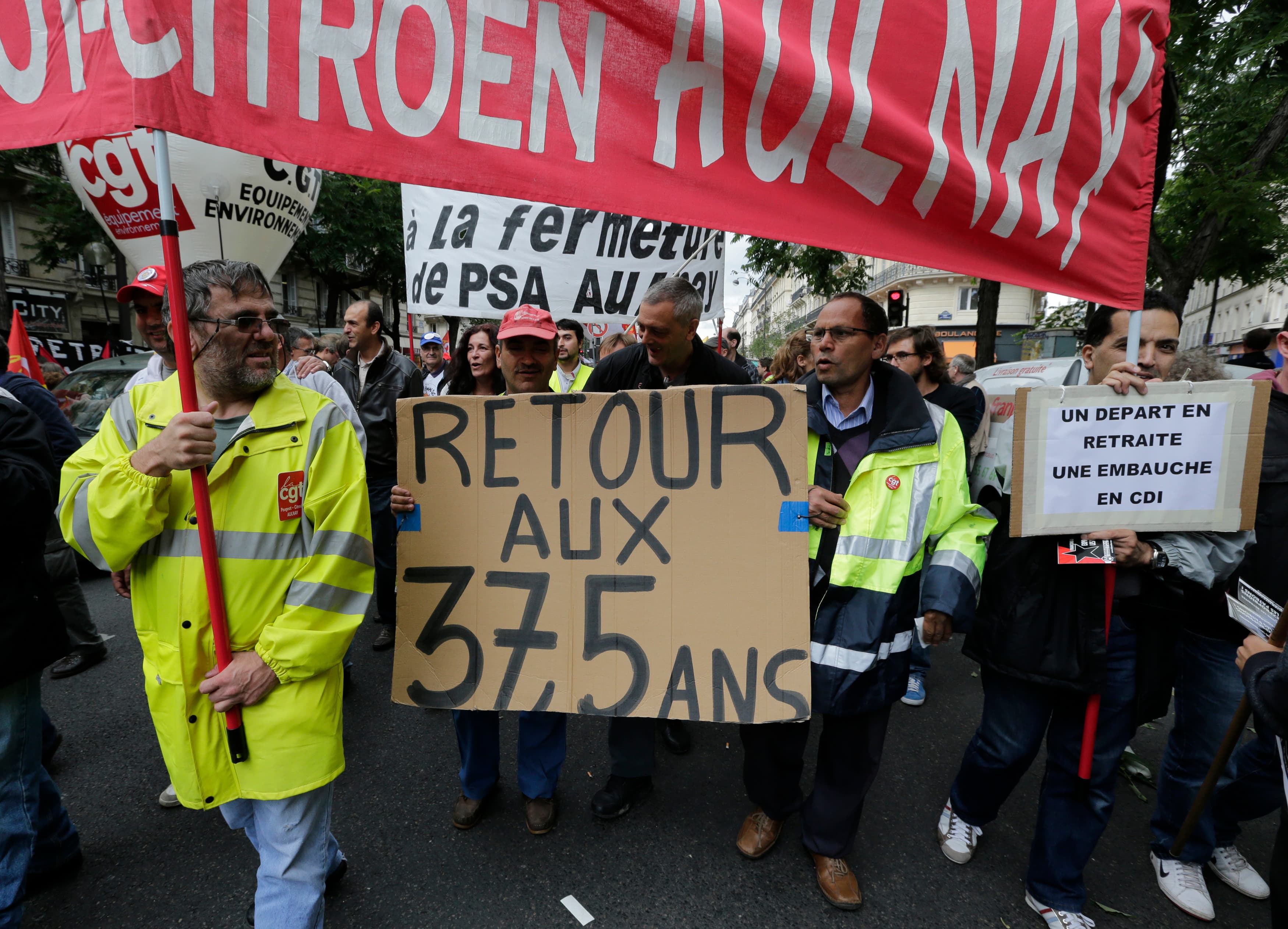 Employees of PSA Peugeot Citroen Aulnay-sous-Bois automotive plant demonstrate over pension reforms in Paris, September 10, 2013. PSA has laid off thousands of workers, in small part because of business lost from Iran sanctions.