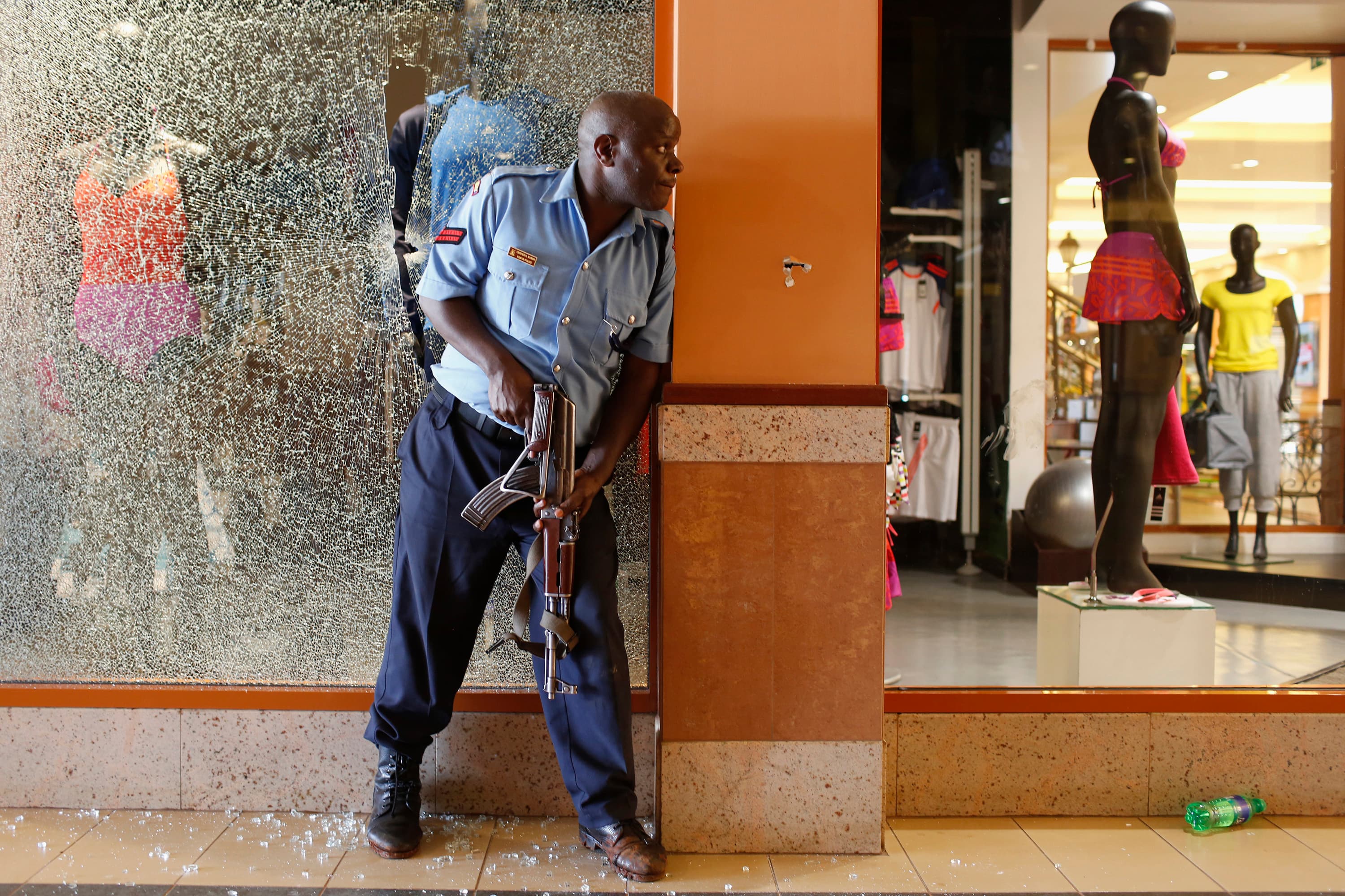 A Kenyan police officer tries to secure an area inside the Westgate Shopping Centre after a militant siege.