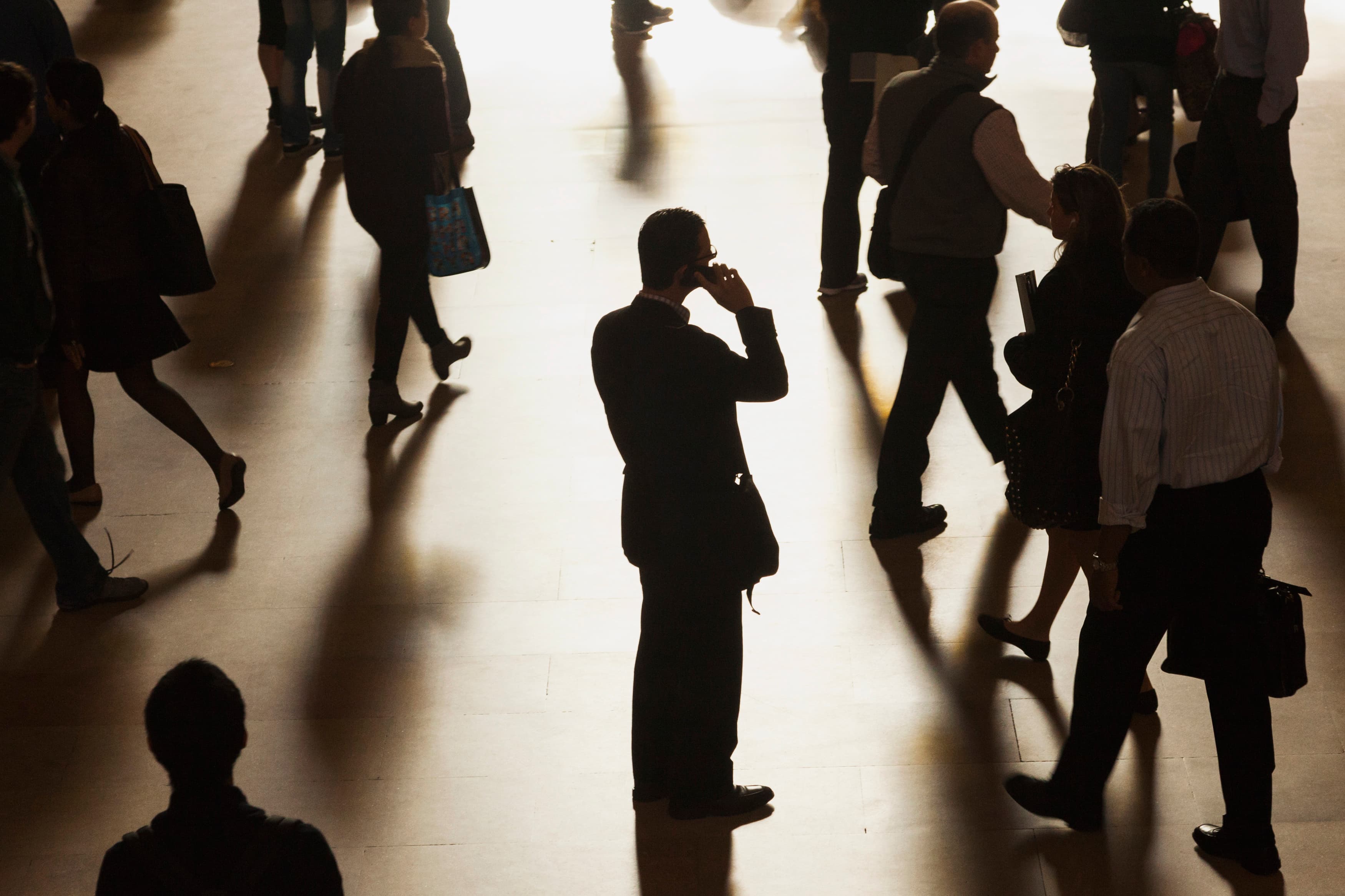A man stands in the middle of Grand Central Terminal as he speaks on a cell phone.