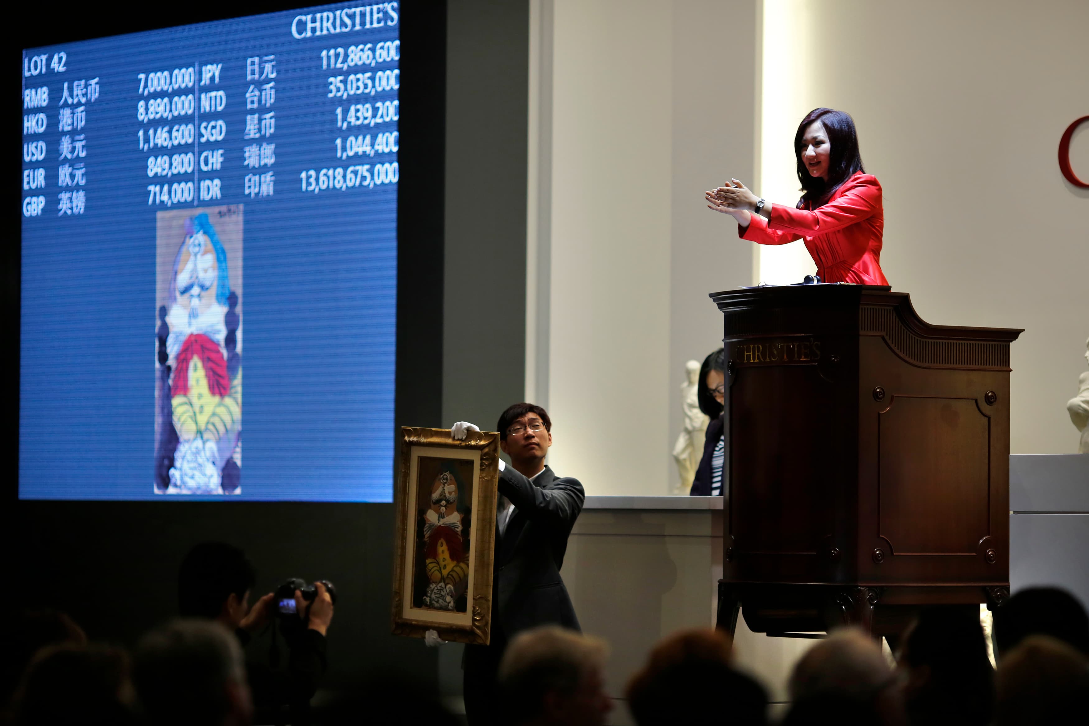 A Christie's moderator facilitates the sale of a piece of artwork titled "Homme Assis" by Pablo Picasso during a Christie's auction in Shanghai on September 26, 2013.