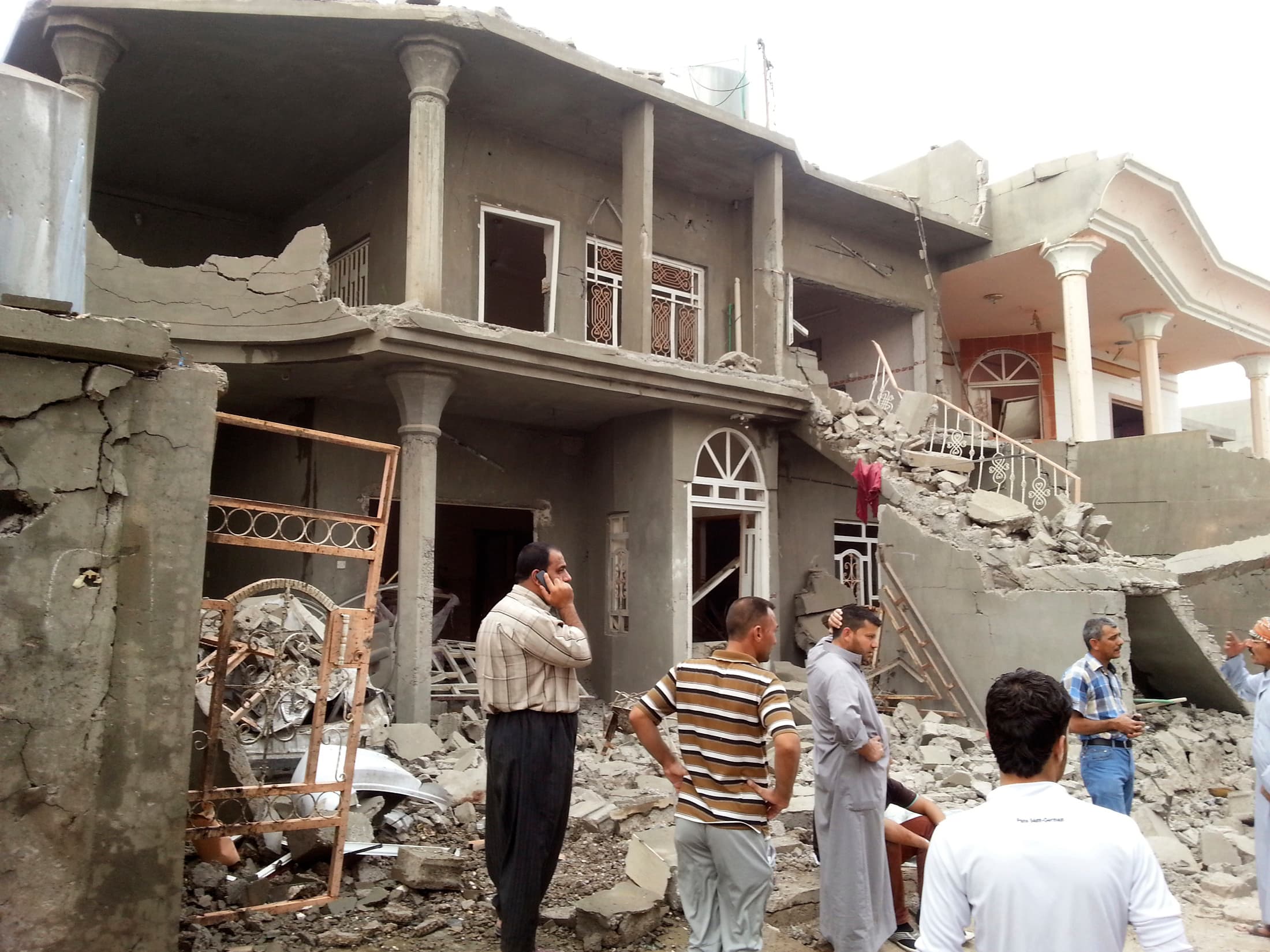 Residents gather at the site of a bomb attack Thursday in the town of Tuz Khurmatu, 106 miles north of Baghdad. Four civilians were killed and 27 others were wounded in the attack, police sources said.