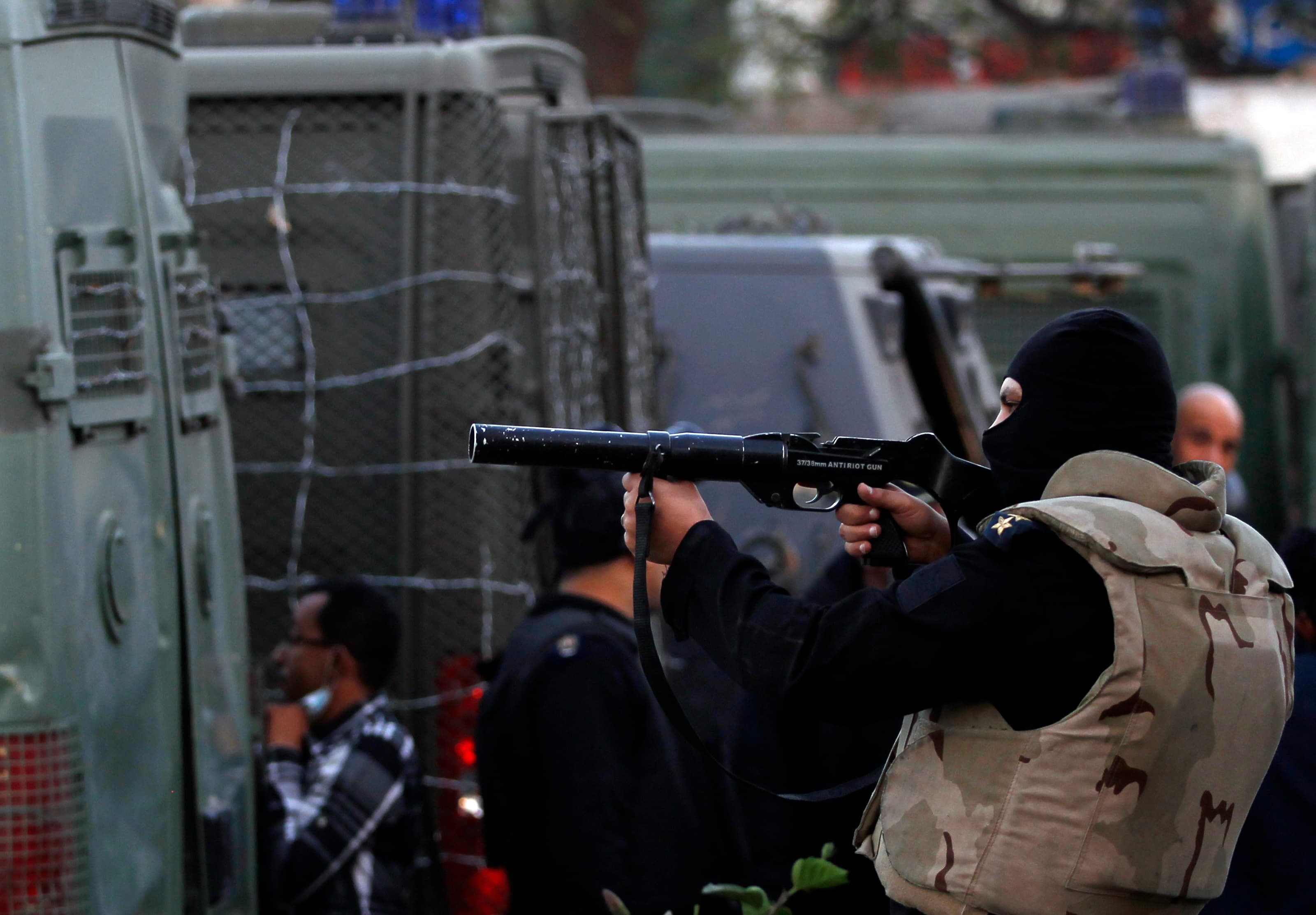 A riot police officer fires tear gas during clashes on Friday with students of Al-Azhar University who support the Muslim Brotherhood and deposed President Mohamed Morsi.