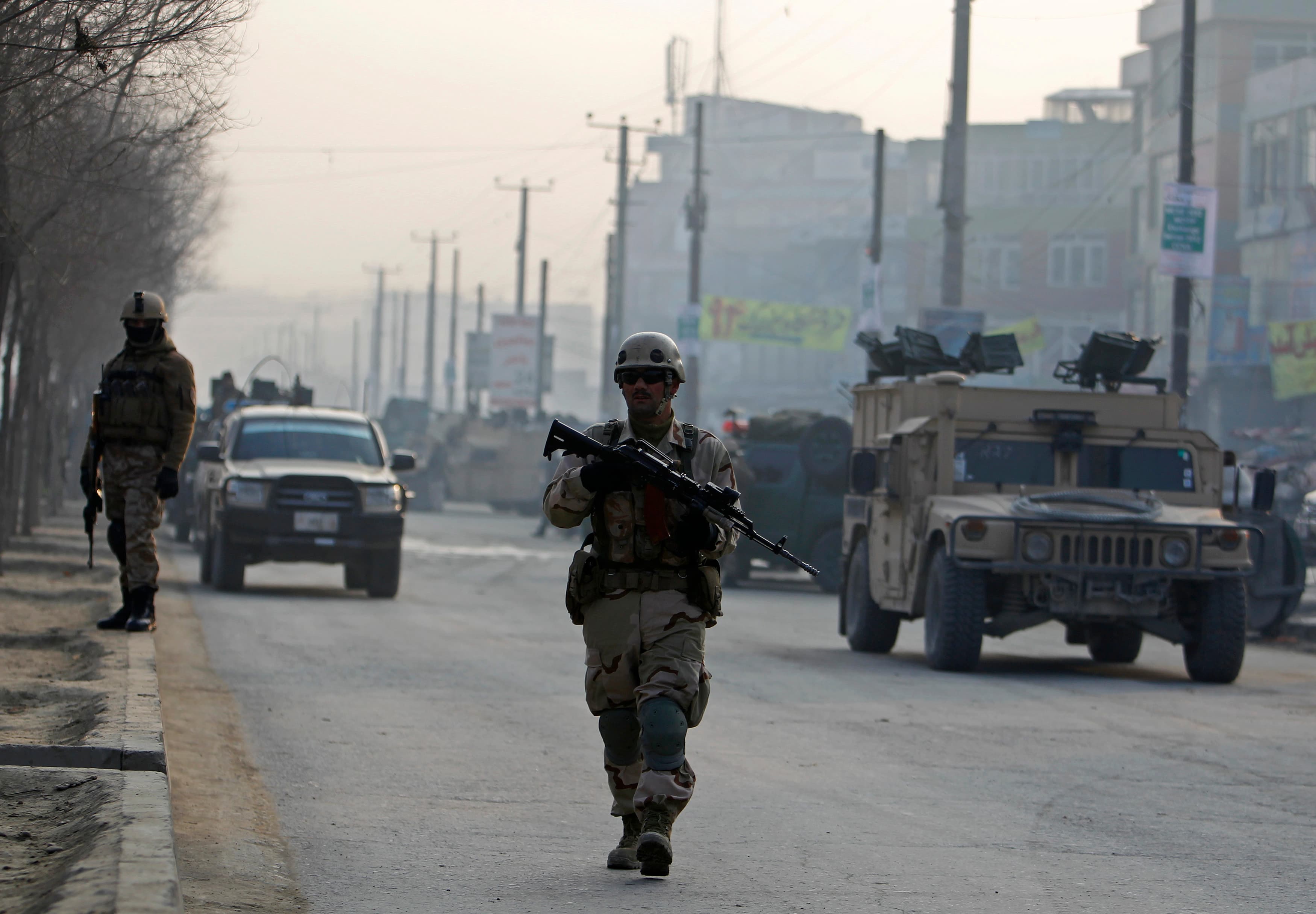 Afghan security personnel keep watch at the site of a suicide attack in Kabul earlier this week. Afghans are now in the lead in providing security throughout the country.