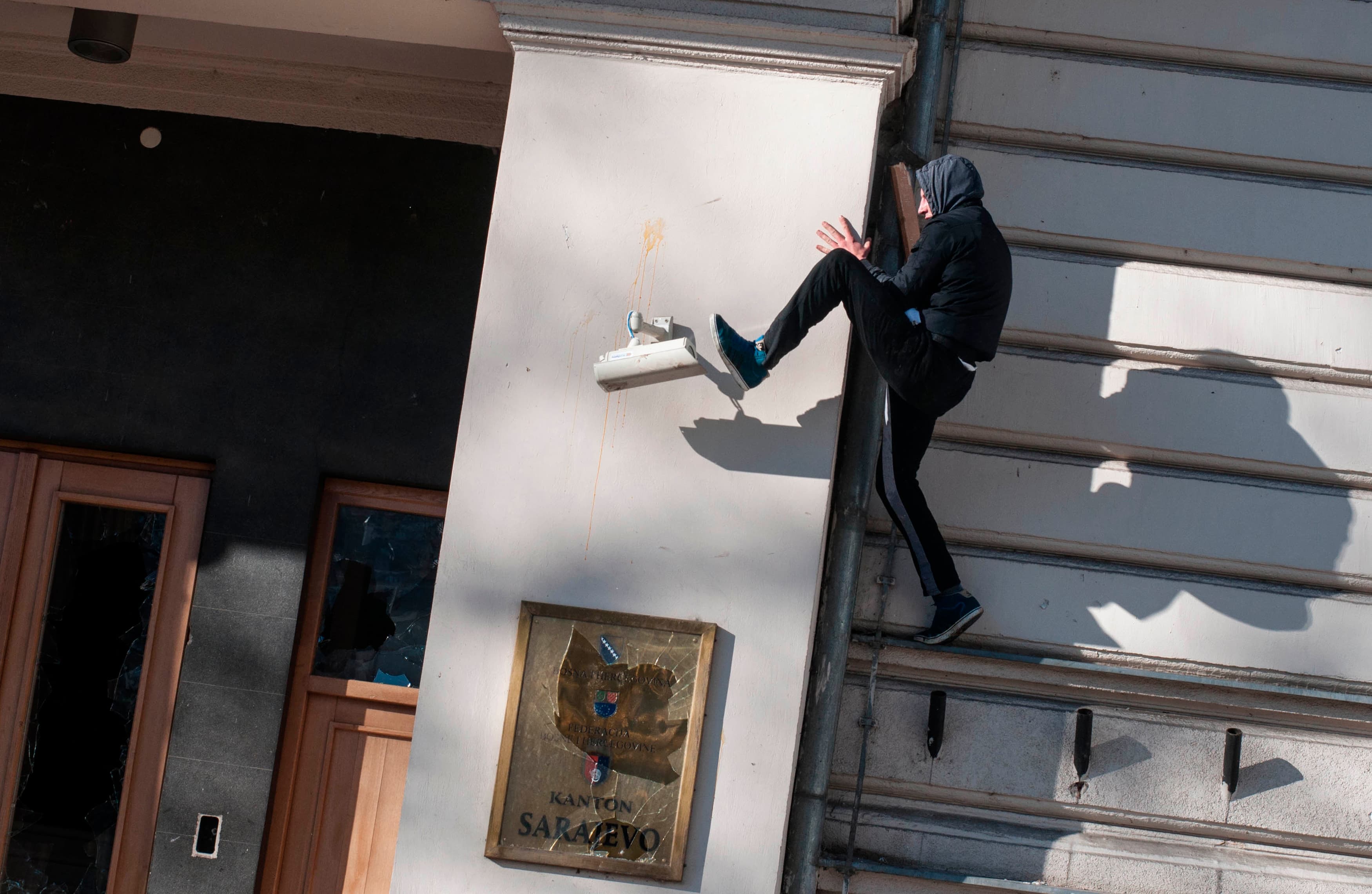 An anti-government protester kicks a surveillance camera during clashes with police in Sarajevo, Bosnia, on February 7, 2014.