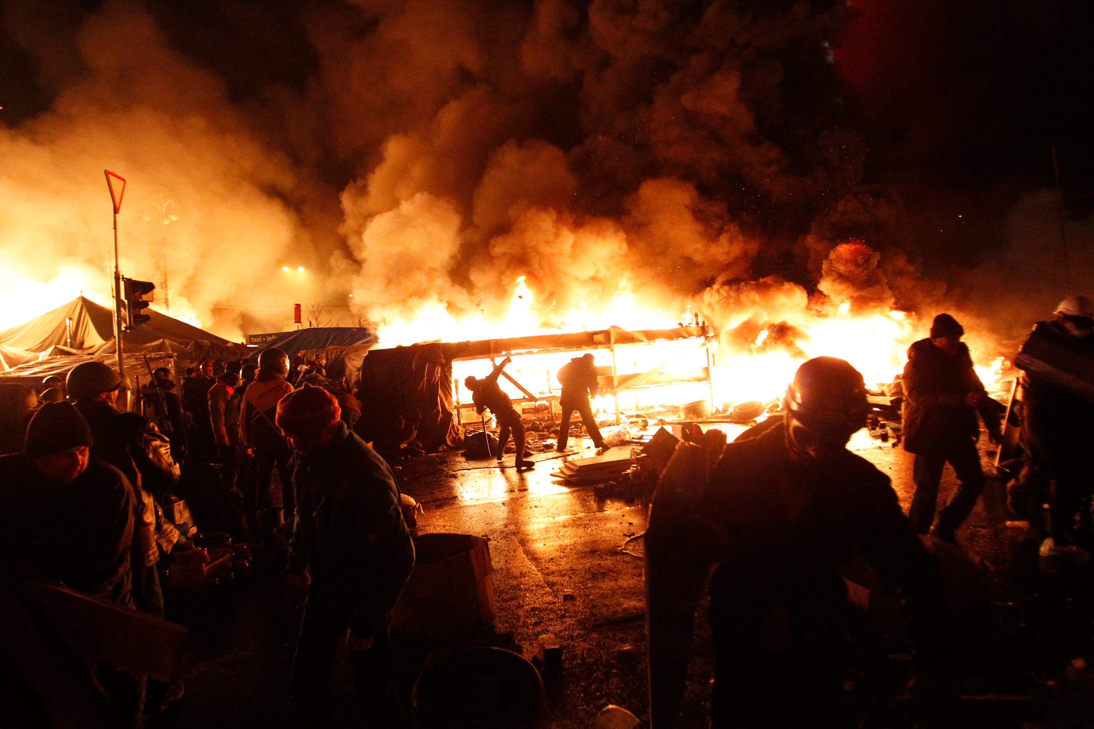 Anti-government protesters throw missiles during clashes with riot police at the Independence Square in Kiev, Wednesday.