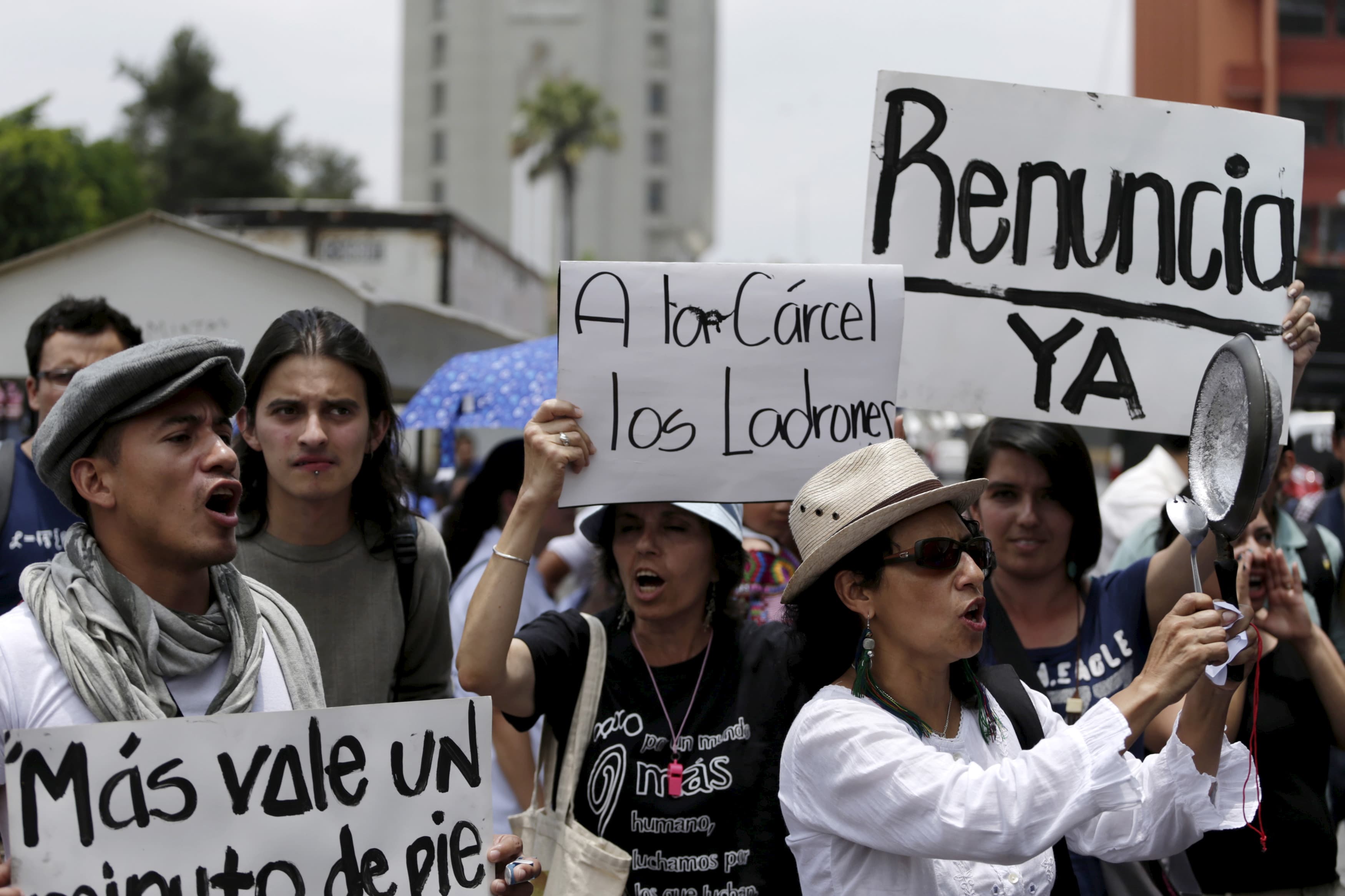 A protester hits a pot during a demonstration to commemorate International Labour Day in downtown Guatemala City, May 1, 2015. International Workers' Day, also known as Labour Day or May Day, commemorates the struggle of workers in industrialised countrie