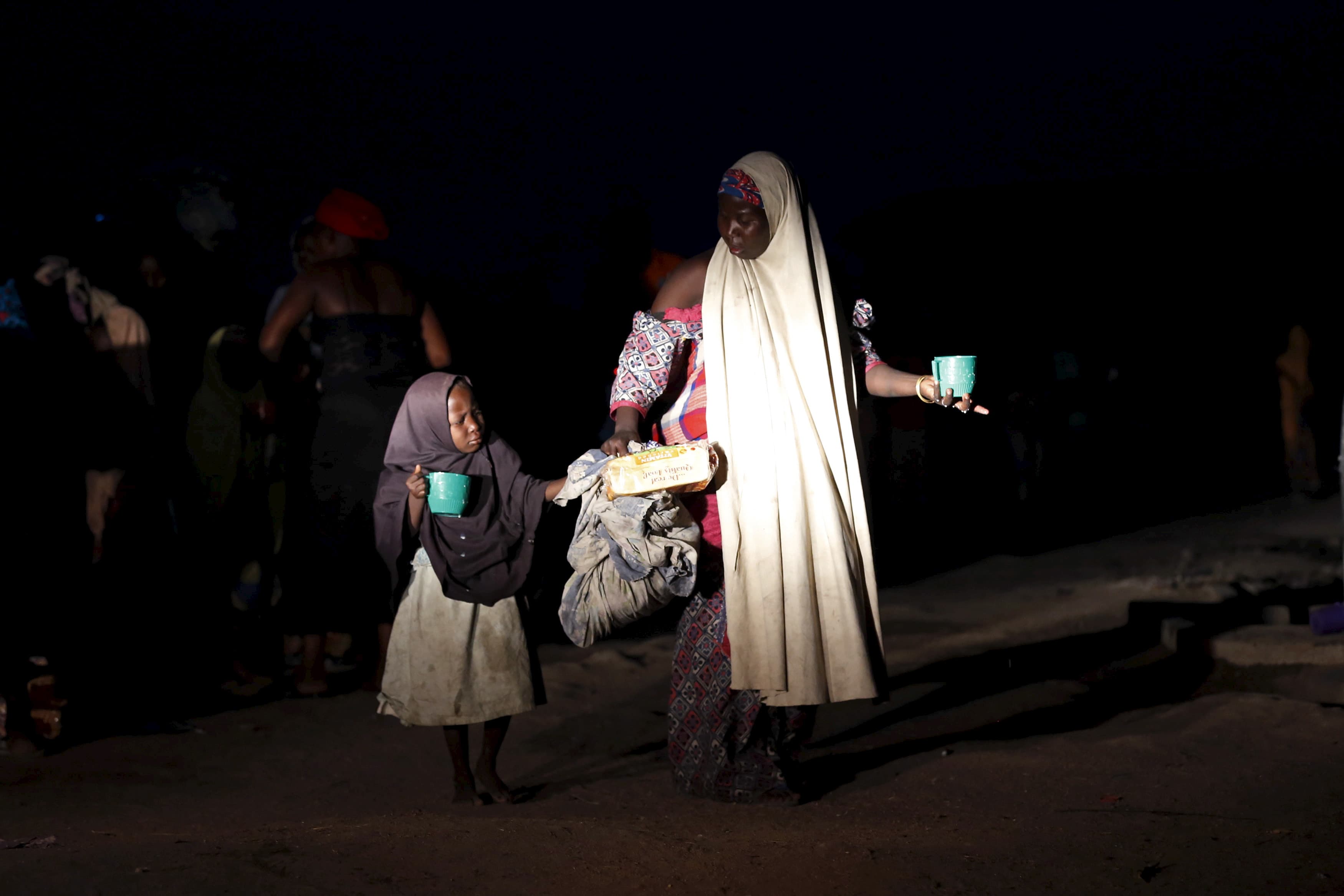 A girl and her mother rescued from Boko Haram in Sambisa Forest by Nigeria's military arrive at a camp for the displaced.