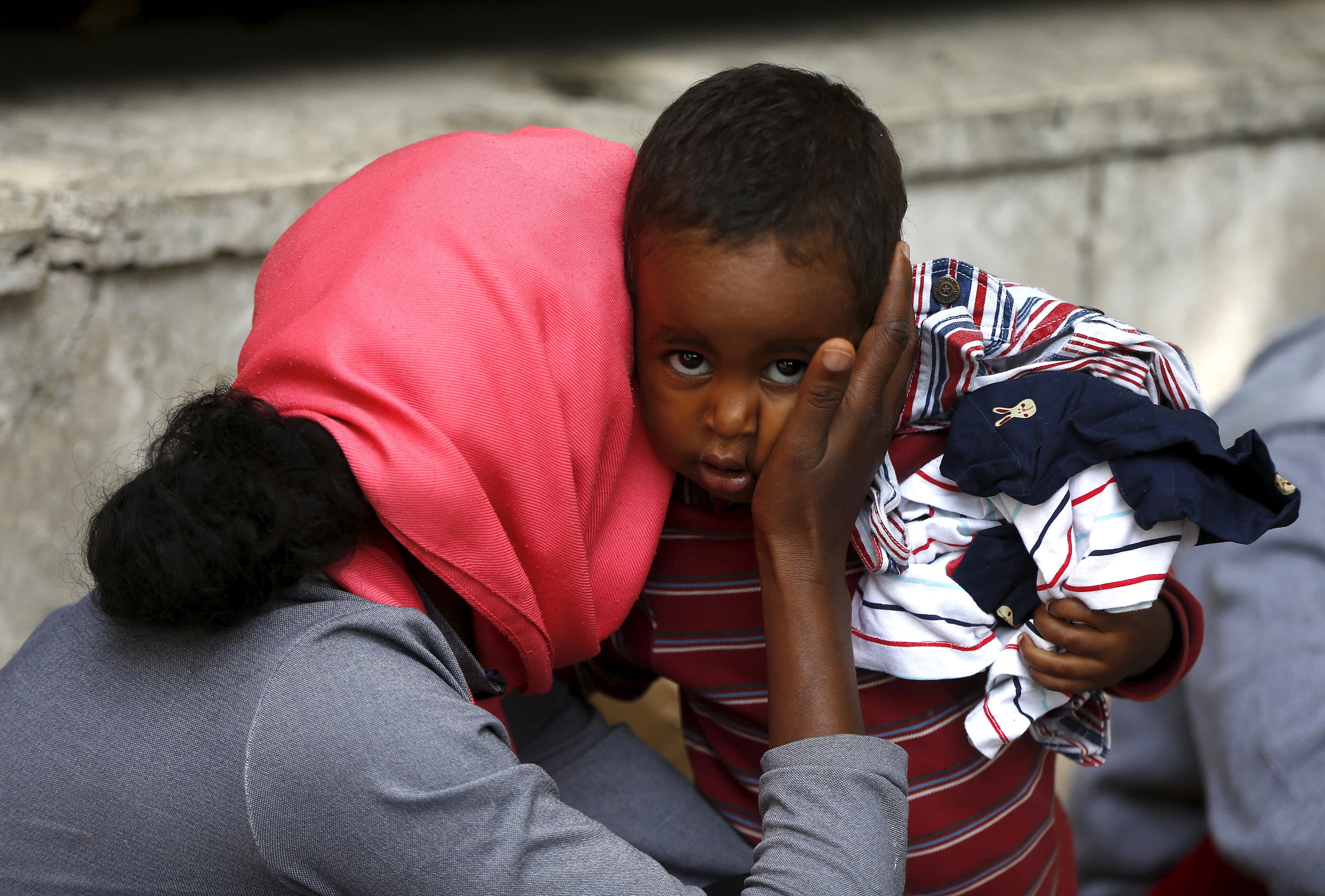 A mother embraces her child next to the Tiburtina train station in Rome.