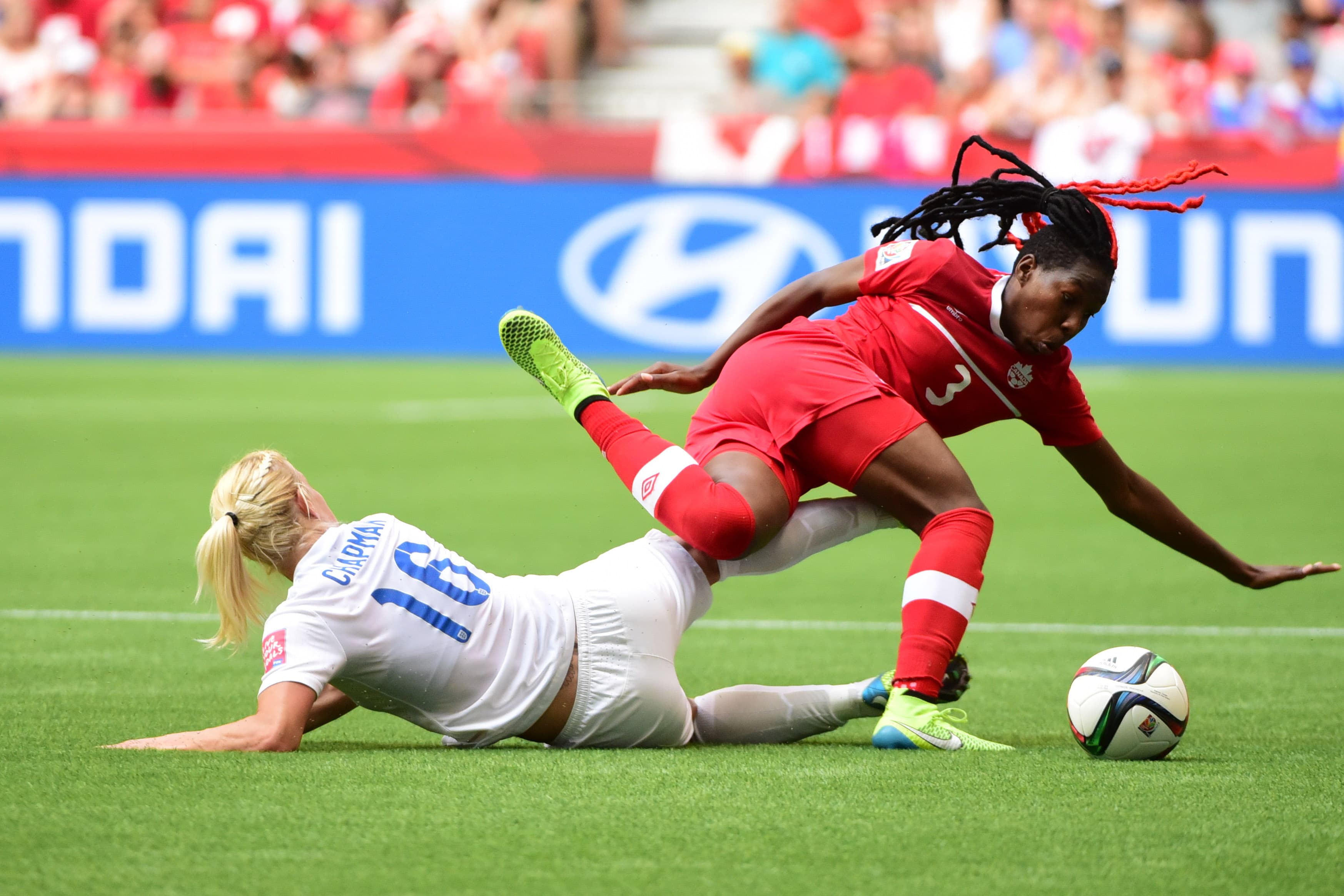 Jun 27, 2015; Vancouver, British Columbia, CAN; Canada defender Kadeisha Buchanan (3) falls against England midfielder Katie Chapman (16) during the second half in the quarterfinals of the FIFA 2015 Women's World Cup at BC Place Stadium.