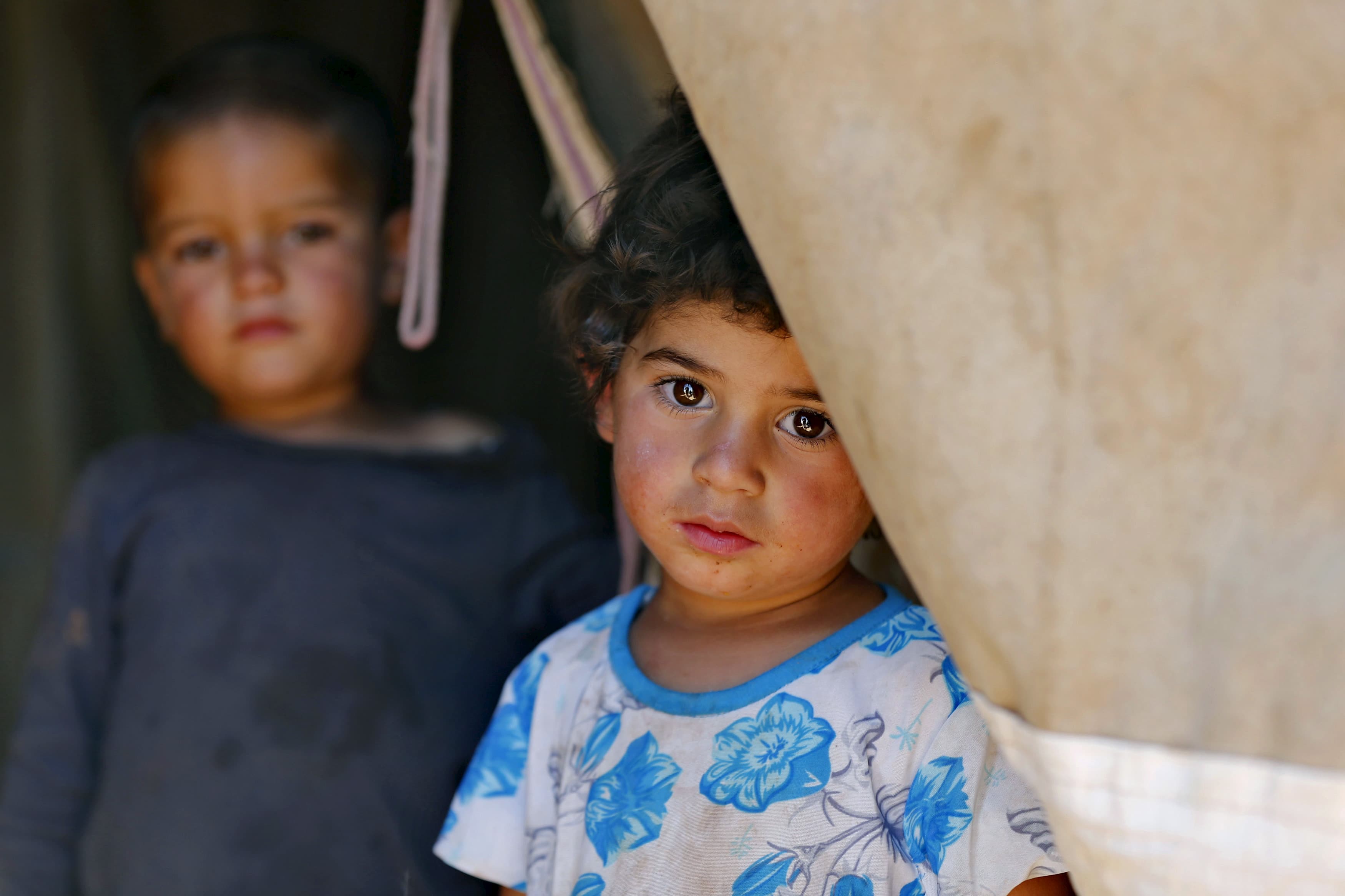 A Syrian refugee child who has been living in a tent in Jordan since fleeing her hometown of Idlib.
