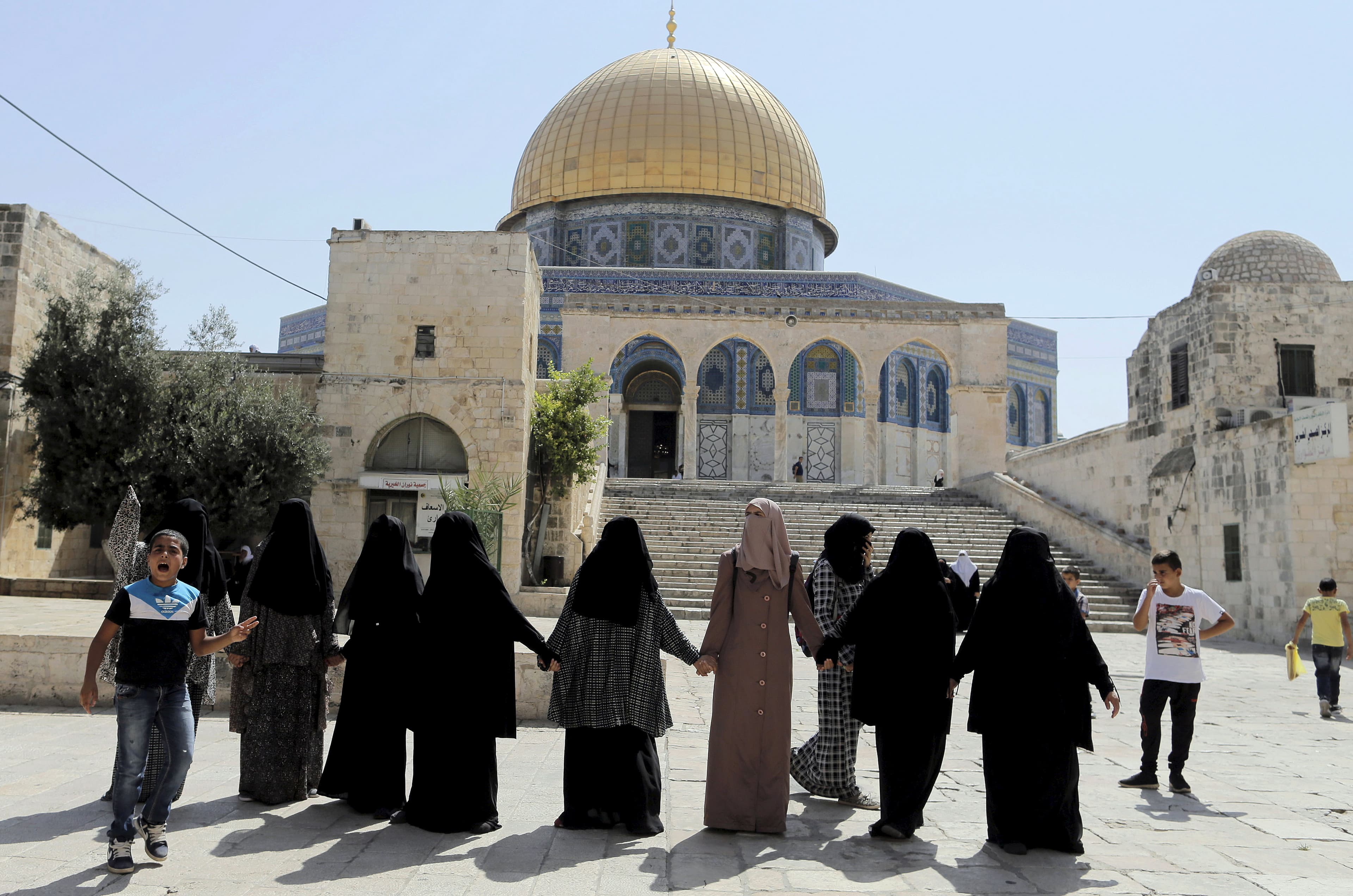A Palestinian youth (L) yells at right-wing Jewish activists (not pictured) as they visit the compound known to Muslims as Noble Sanctuary and to Jews as Temple Mount in Jerusalem's Old City July 28, 2015.