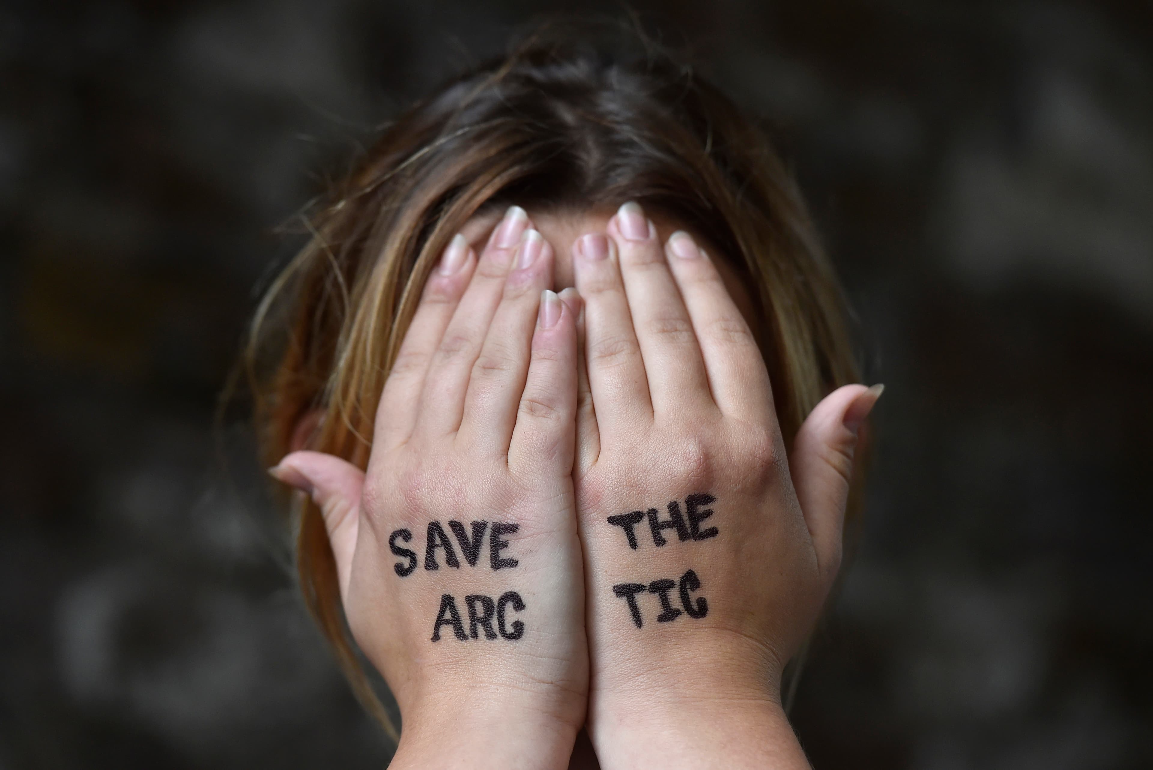 British singer Charlotte Church holds her hands to her face during an environmental protest near the offices of Shell in central London, Britain August 26, 2015.