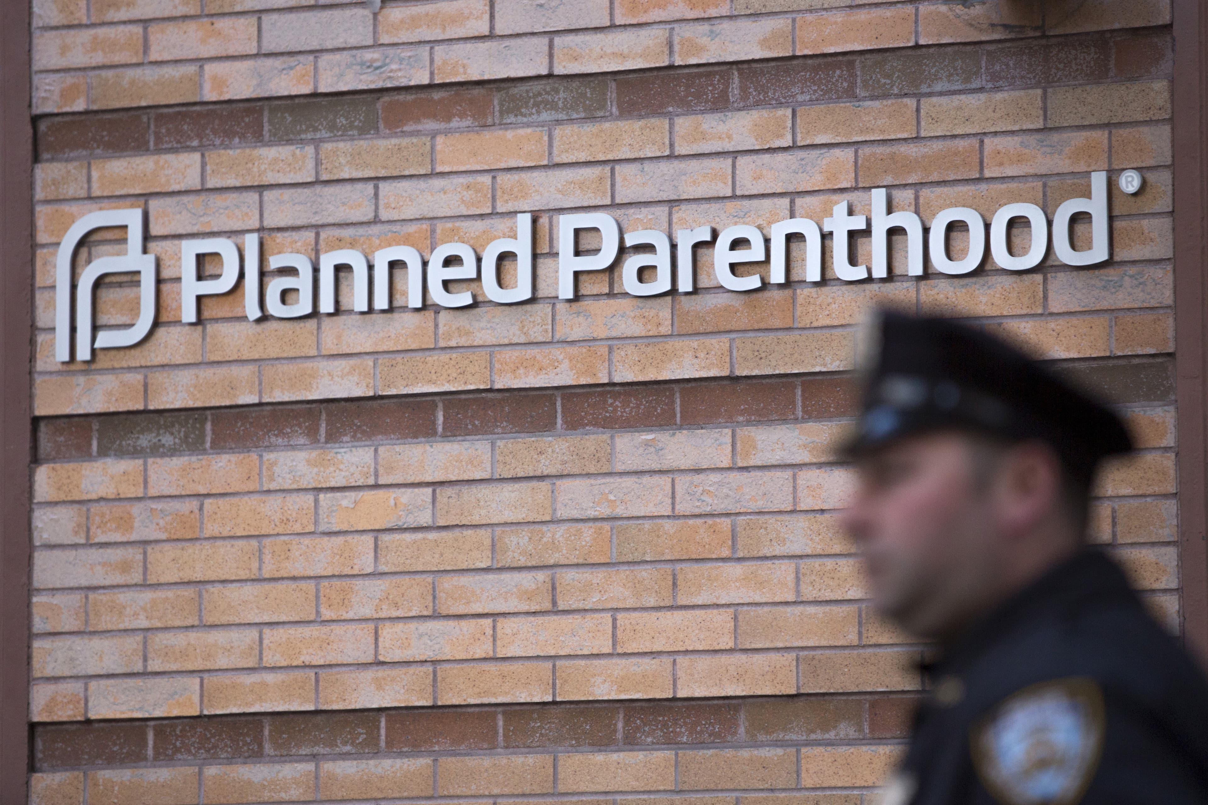 A member of the New York Police Department stands outside a Planned Parenthood clinic in New York, a day after the shootings in Colorado Springs.
