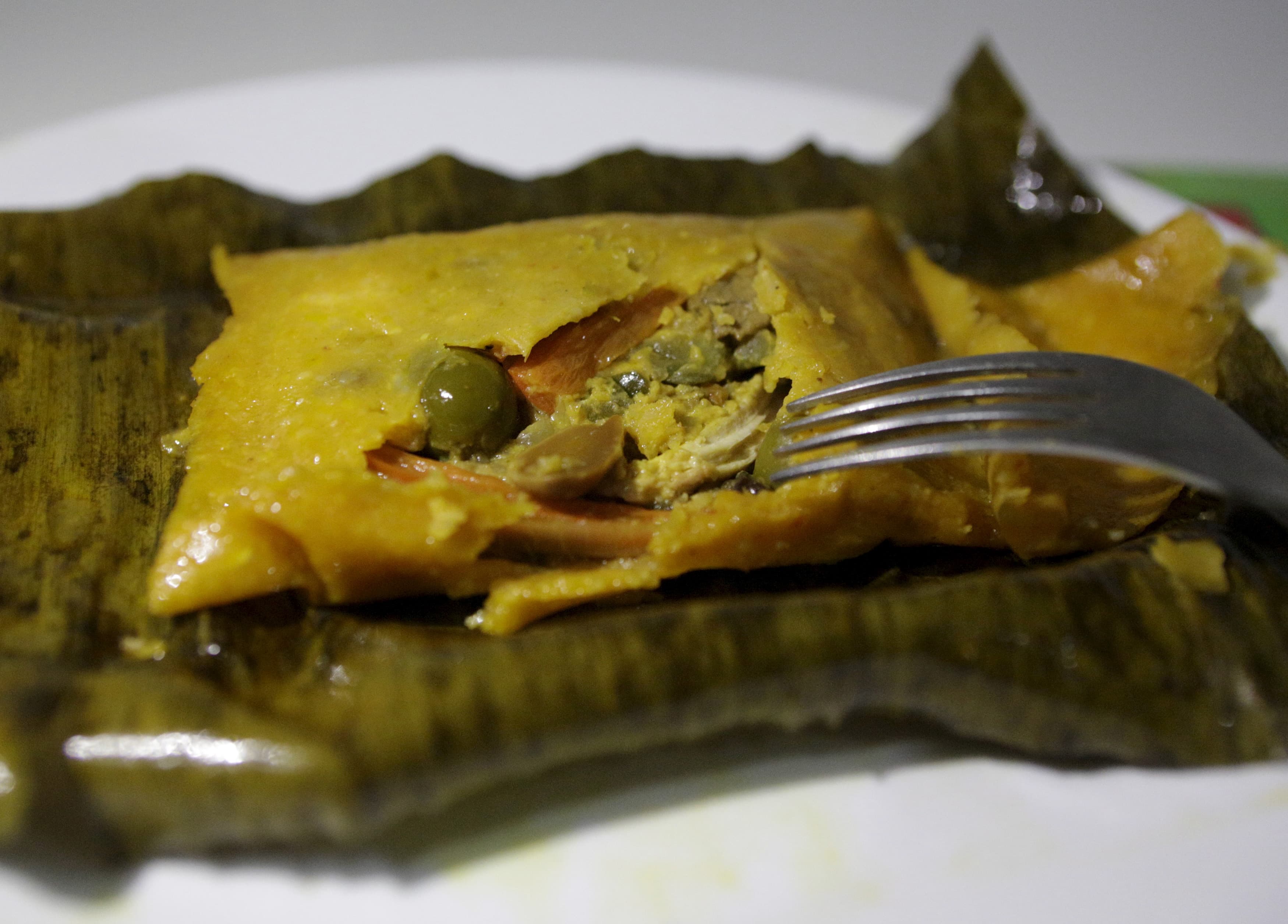A Hallaca is a typical Venezuelan dish made out of cornmeal and stuffed with beef, pork, chicken, raisins, capers and olives and then wrapped in a banana leaf and traditionally served on Christmas and New Year's Eve.