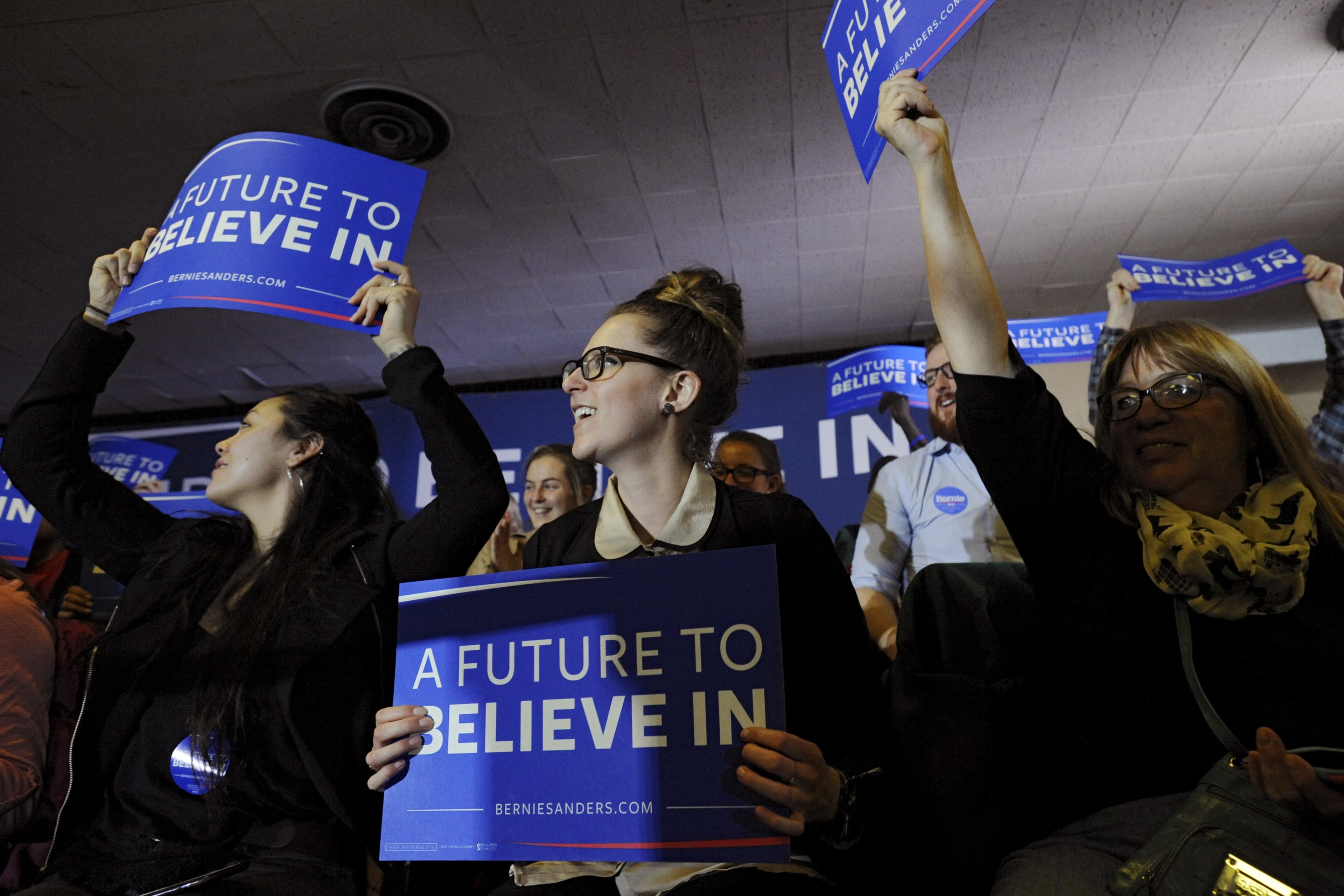 Supporters of US Democratic presidential candidate Bernie Sanders cheer ahead of his speech at a town hall campaign event in Clinton, Iowa.
