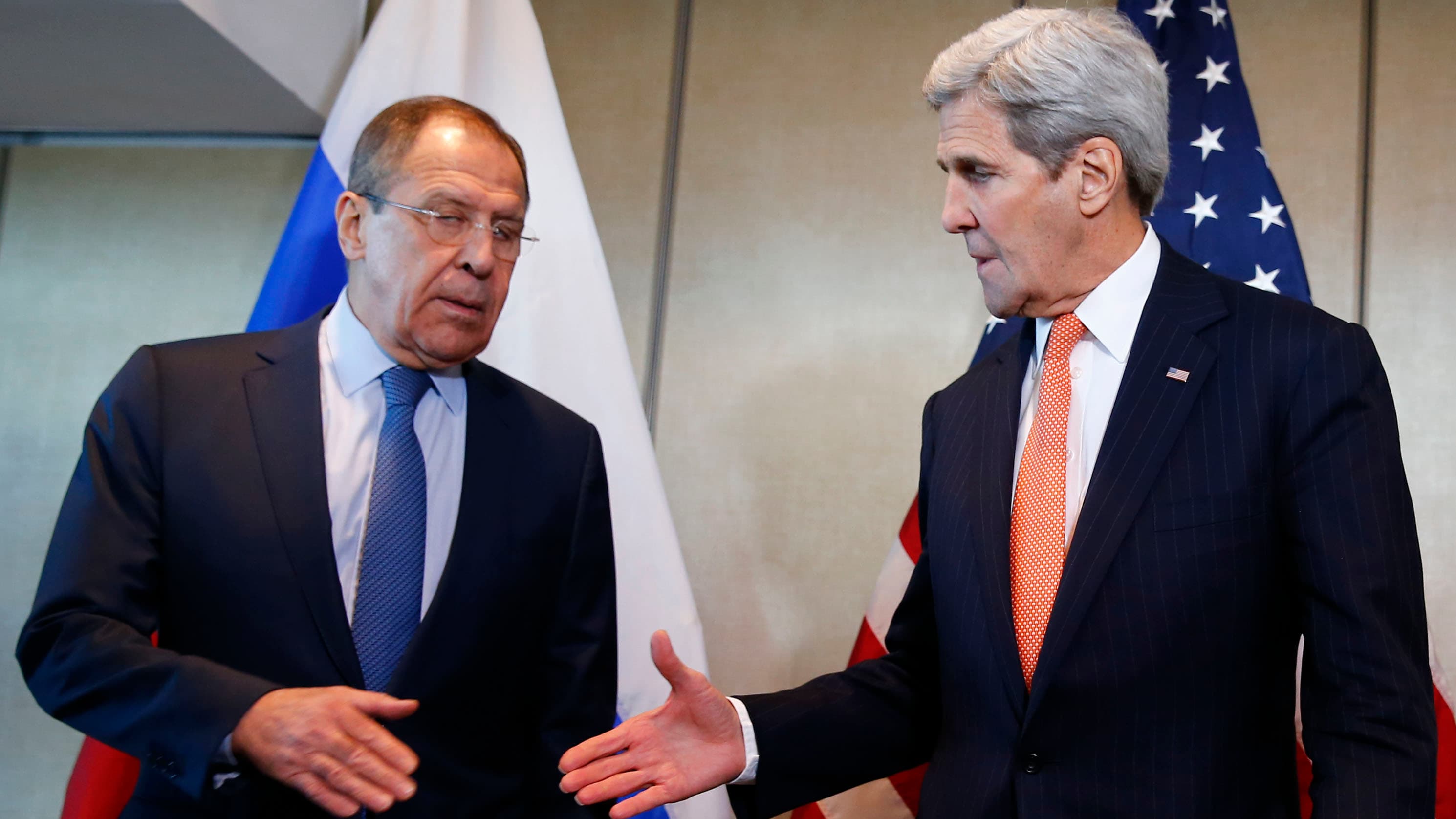 A hesitant deal in Munich. Secretary of State John Kerry prepares to shake hands with his Russian counterpart, Sergei Lavrov.