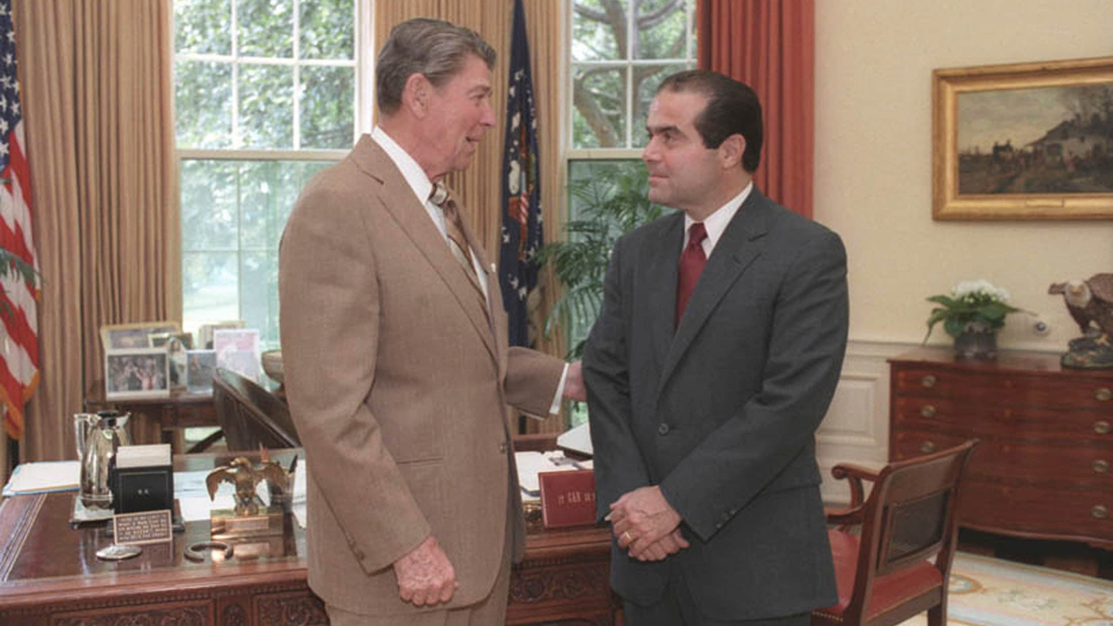 President Ronald Reagan speaks with Supreme Court Justice nominee, Antonin Scalia, in the White House Oval Office in Washington DC in 1986