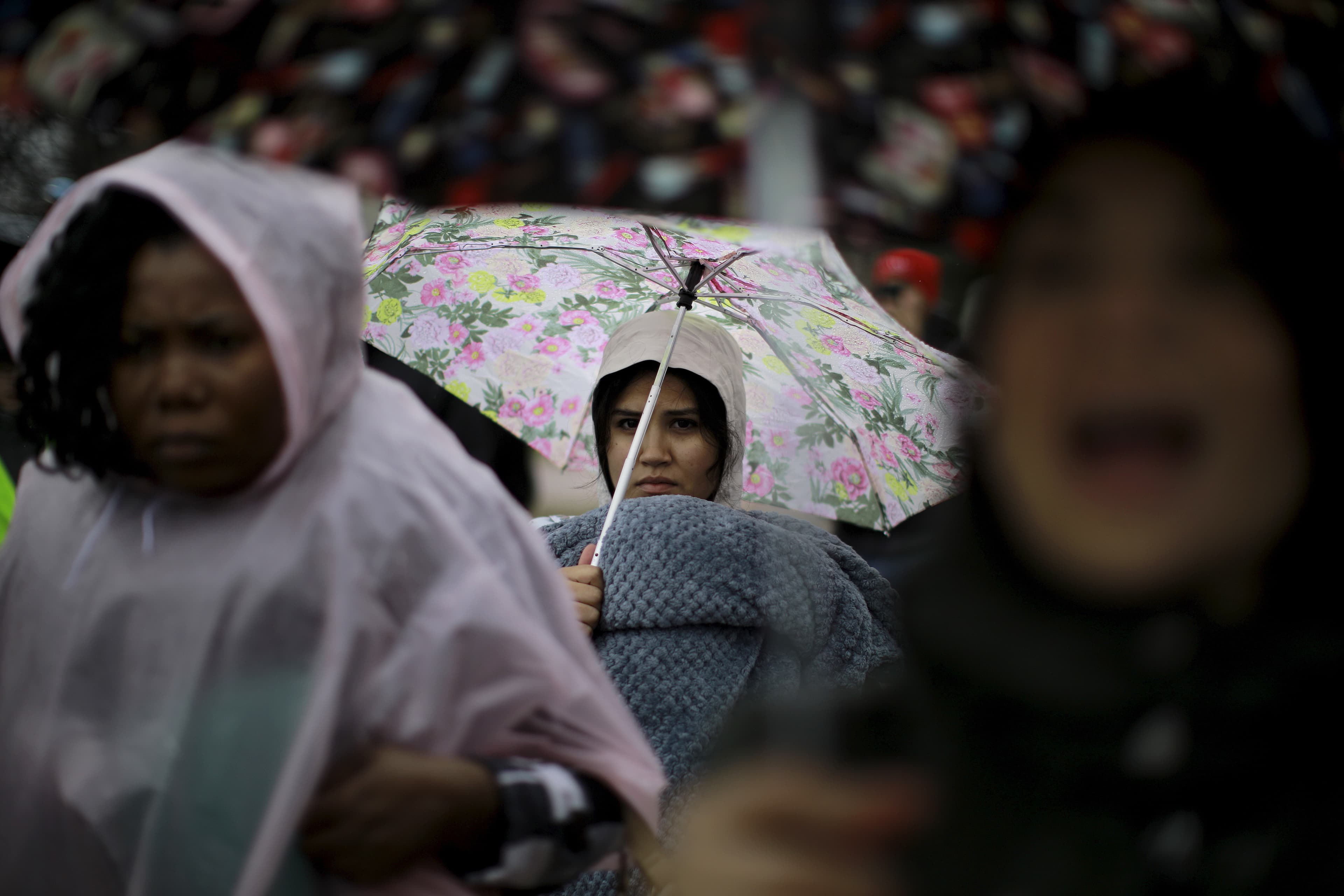 Anti-deportation protesters stand outside the White House.
