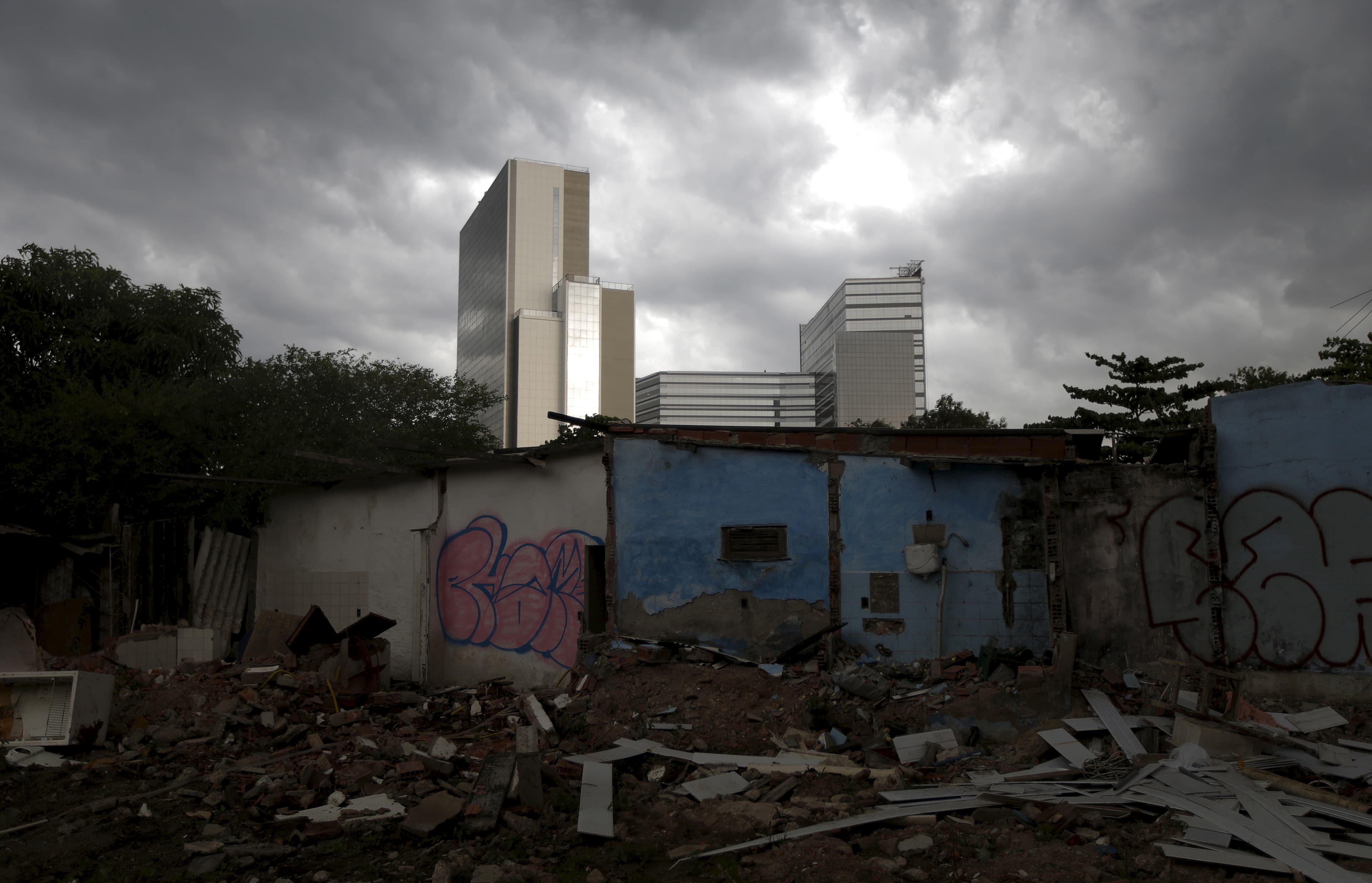 Partially demolished houses in the Vila Autodromo slum with the Rio 2016 Olympic Park in the background in Rio de Janeiro, Brazil.