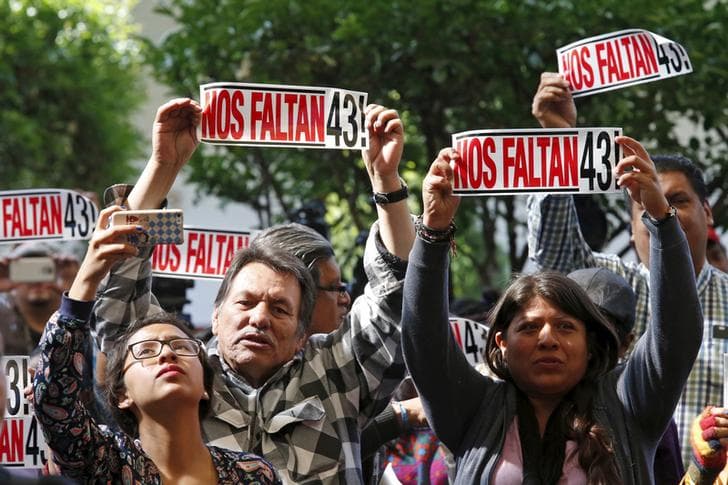Activists hold a sign that reads "We are missing 43" during the delivery of the final report of the 43 missing students from the Ayotzinapa teacher's training college by members of the Inter-American Commission on Human Rights.