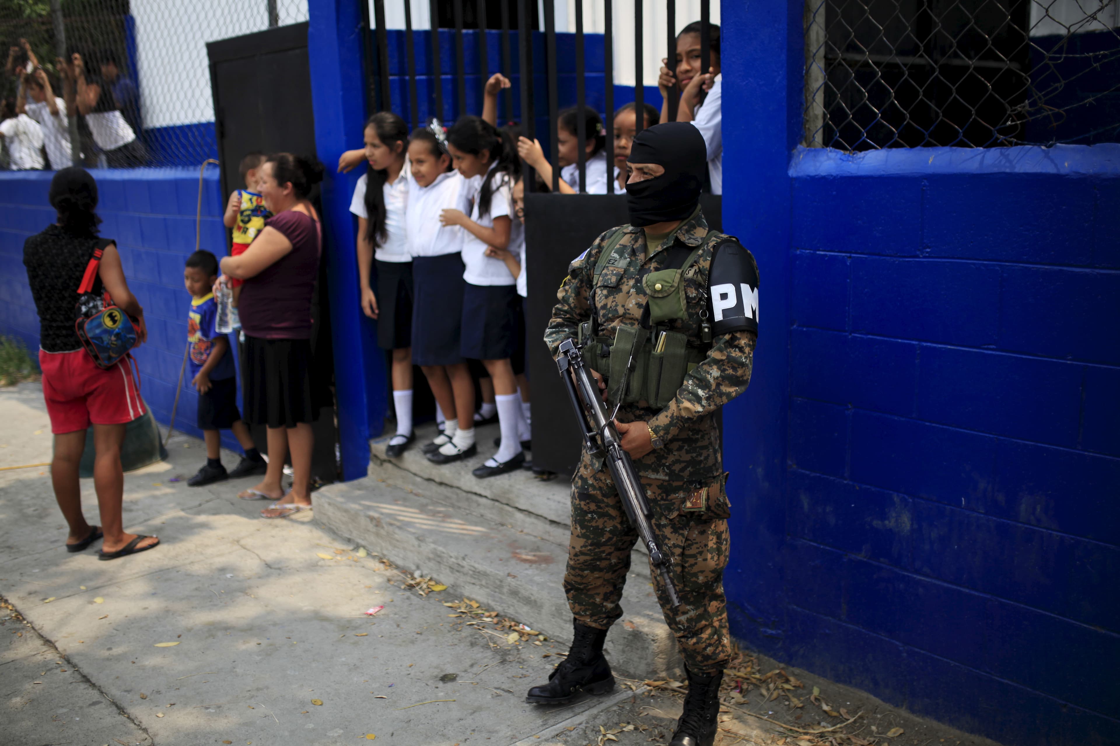 Salvadoran military police stand guard outside a school in Soyapango's La Campanera neighborhood on the outskirts of San Salvador.