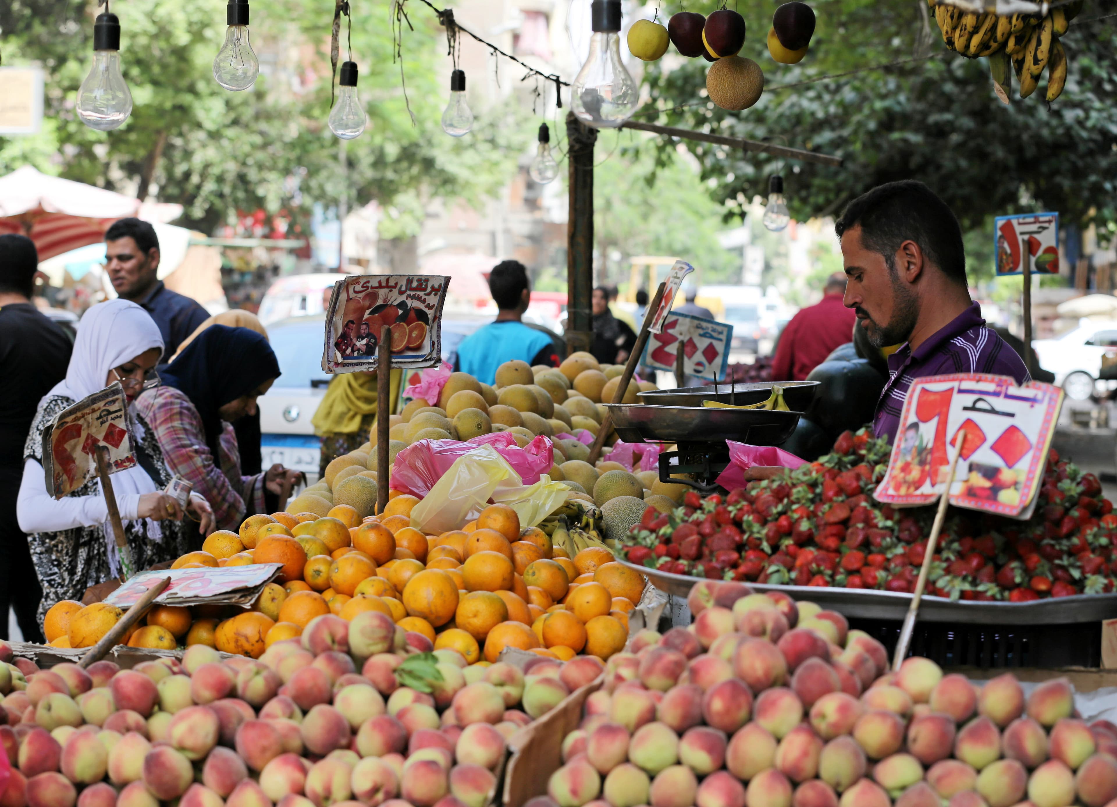 An Egyptian women shops at a vegetable market in Cairo, Egypt