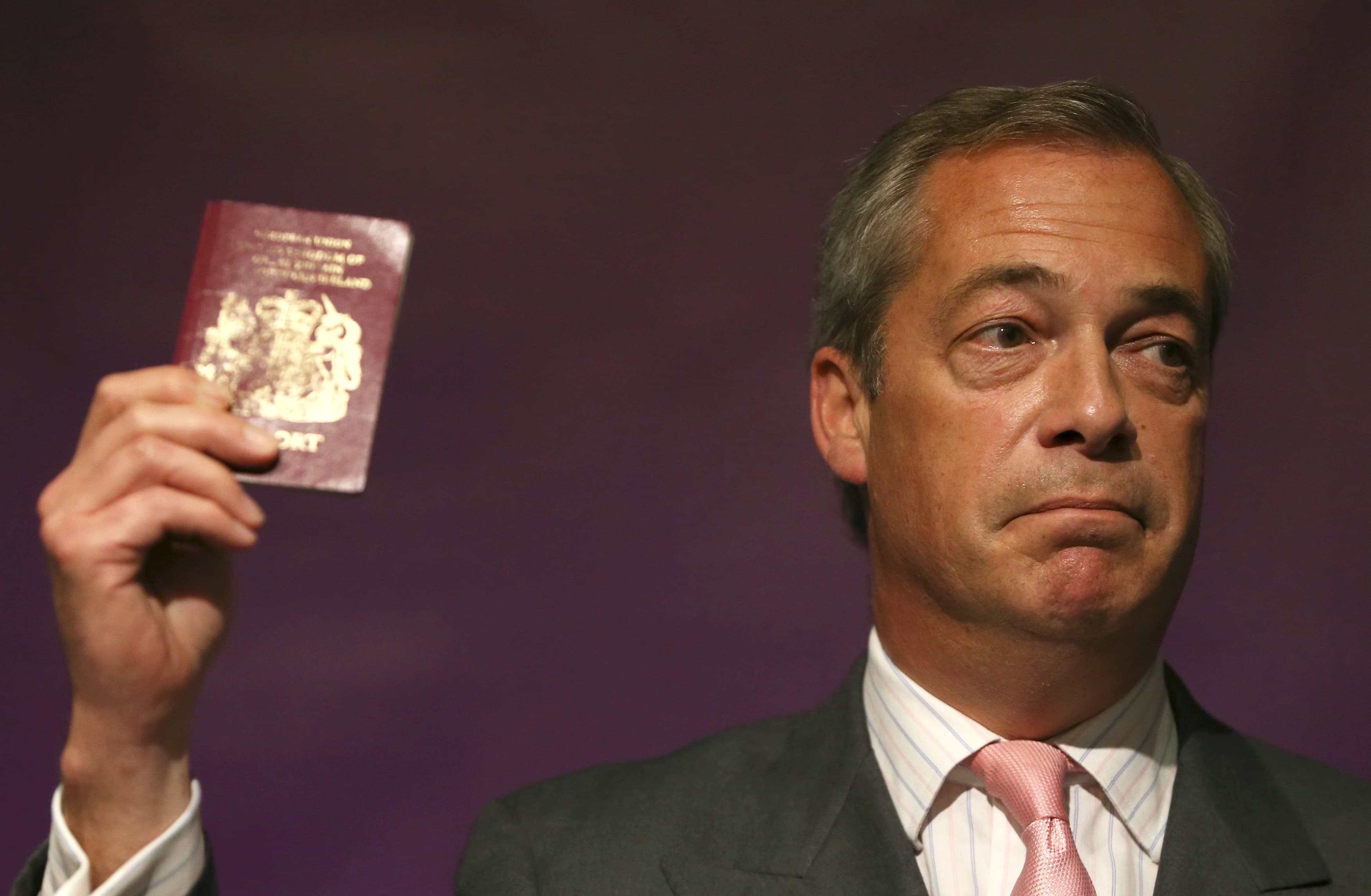 Leader of the United Kingdom Independence Party (UKIP) Nigel Farage holds his passport as he speaks at pro Brexit event in London, Britain June 3, 2016.