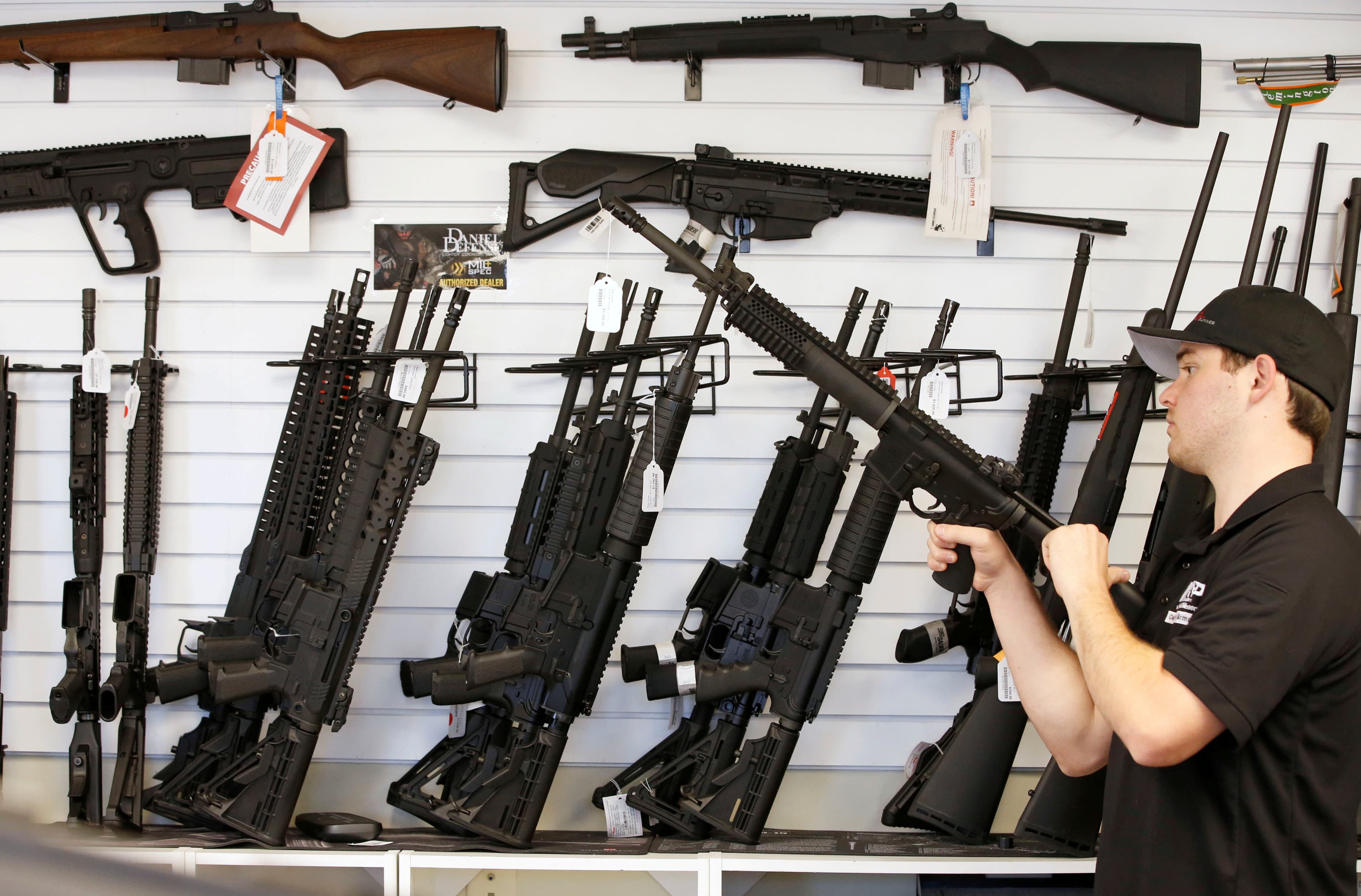 Salesman Ryan Martinez clears the chamber of an AR-15 at the "Ready Gunner" gun store In Provo, Utah, U.S. in Provo, Utah, U.S., June 21, 2016.