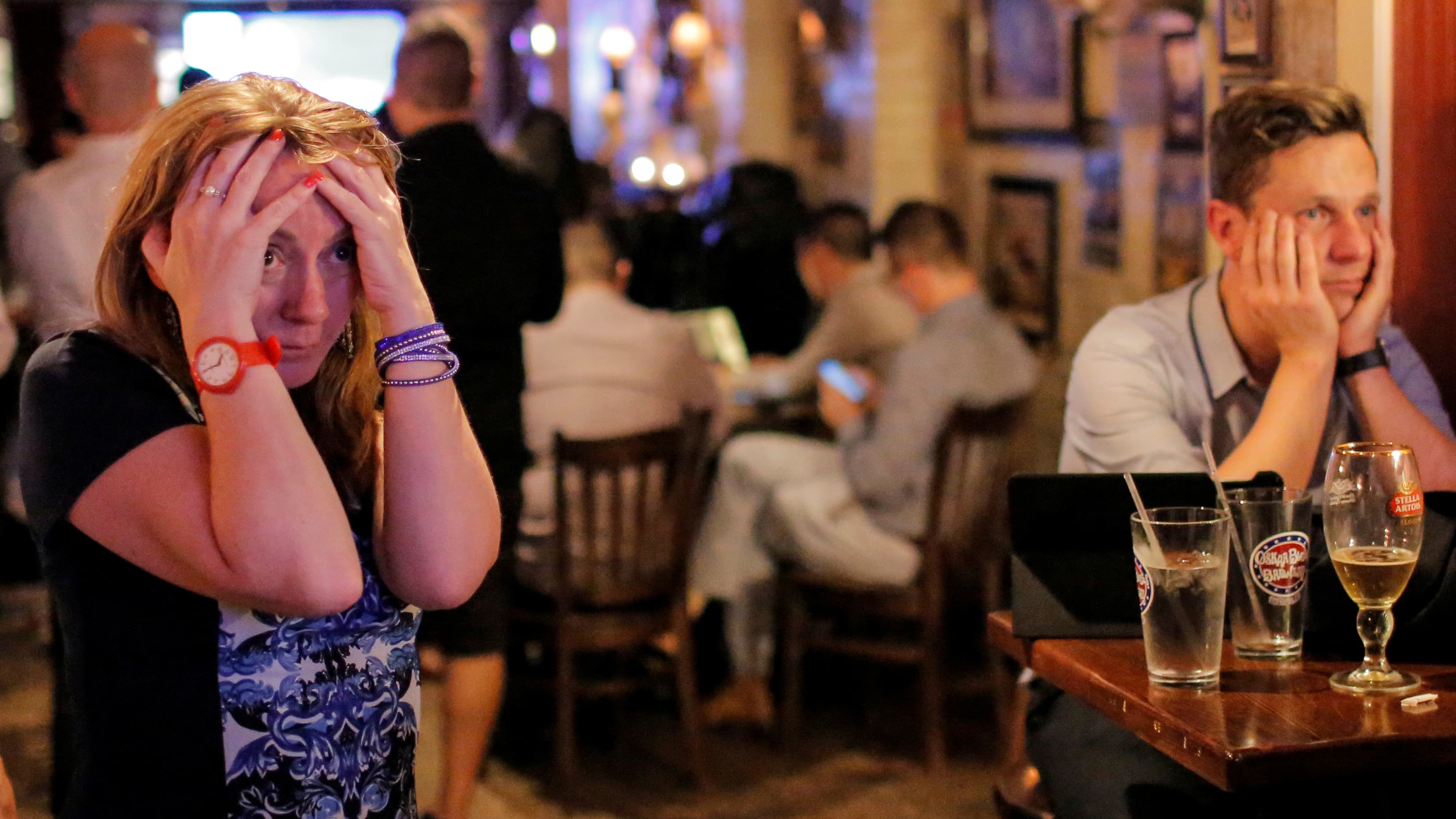 People gathered in The Churchill Tavern, a British themed bar, react as the BBC predicts Britain will leave the European Union, in Manhattan.