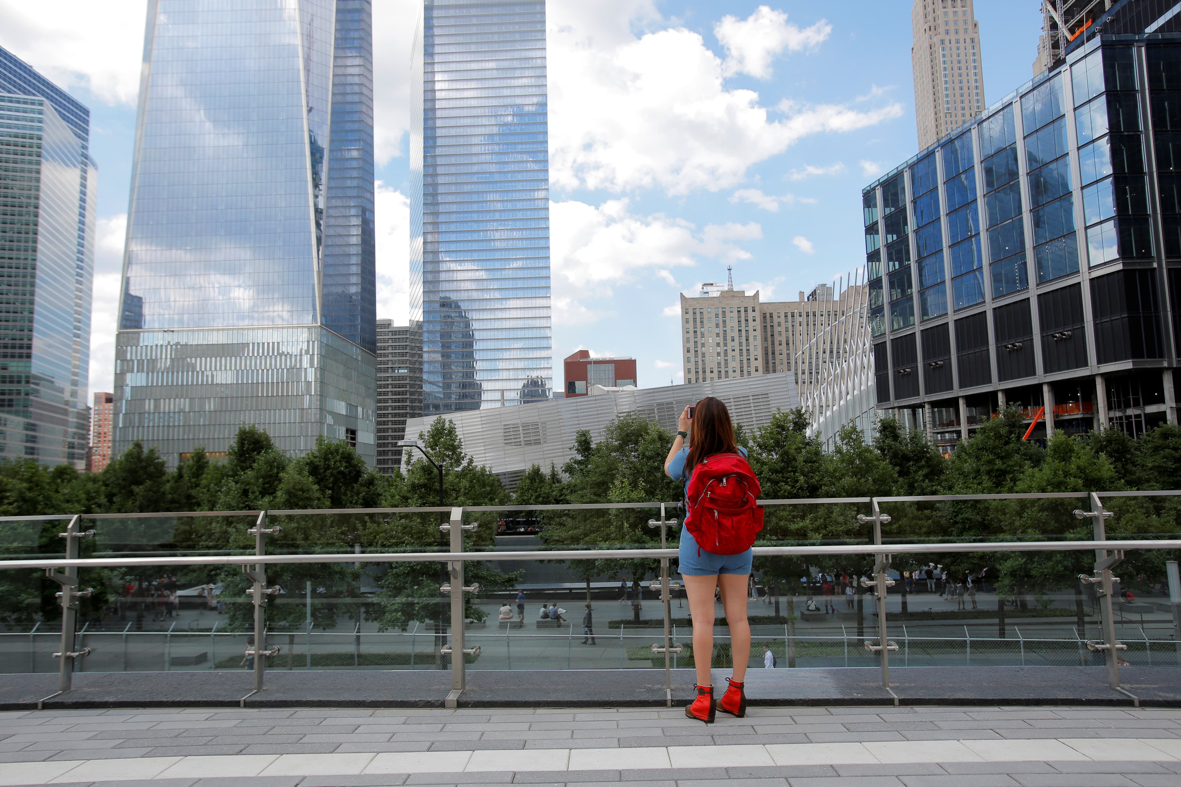 A woman takes a photo from the newly opened Liberty Park above Liberty Street on the World Trade Center site in Manhatten.