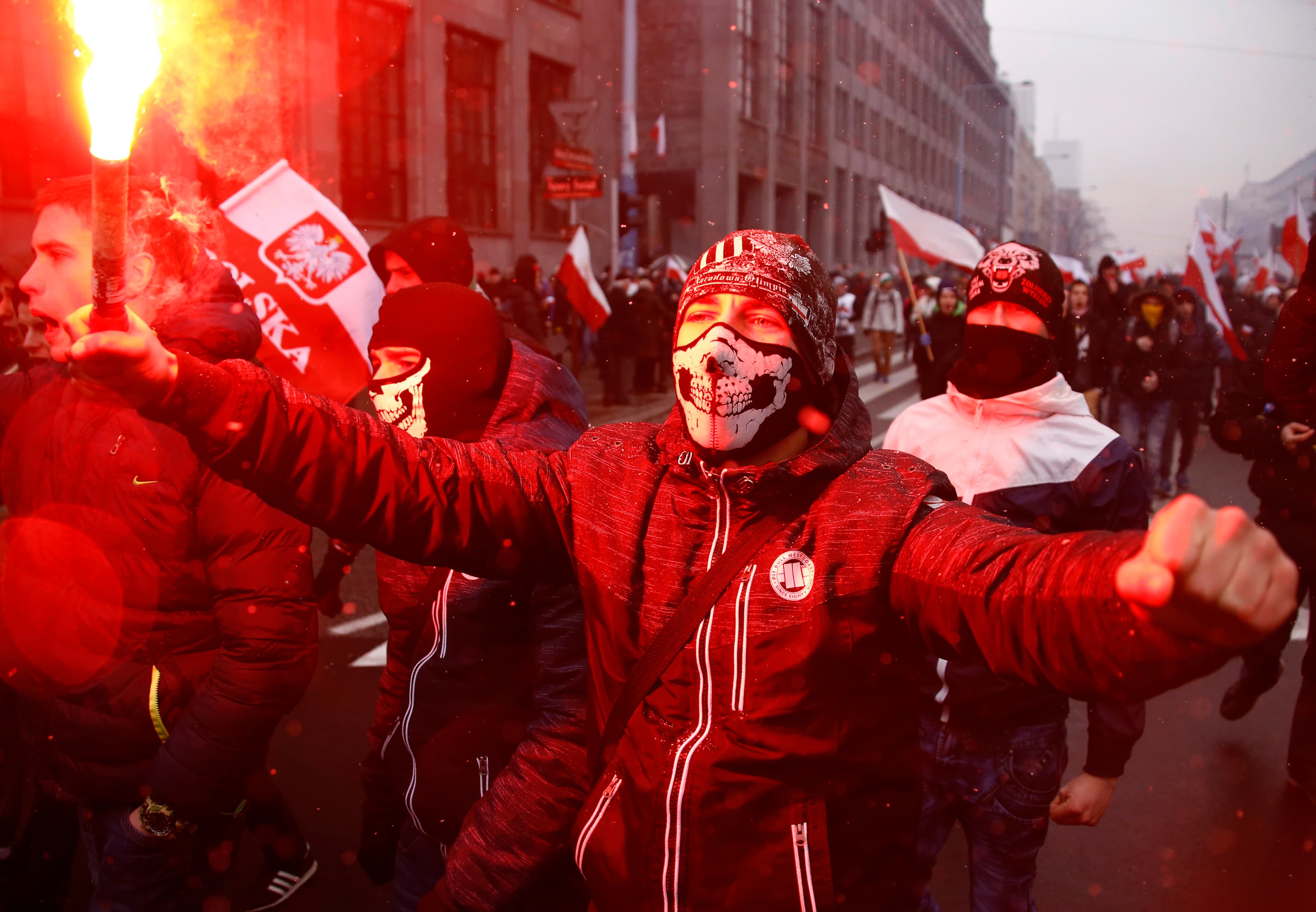 Protesters light flares and carry Polish flags during a rally, organised by far-right, nationalist groups, to mark the anniversary of Polish independence in Warsaw.