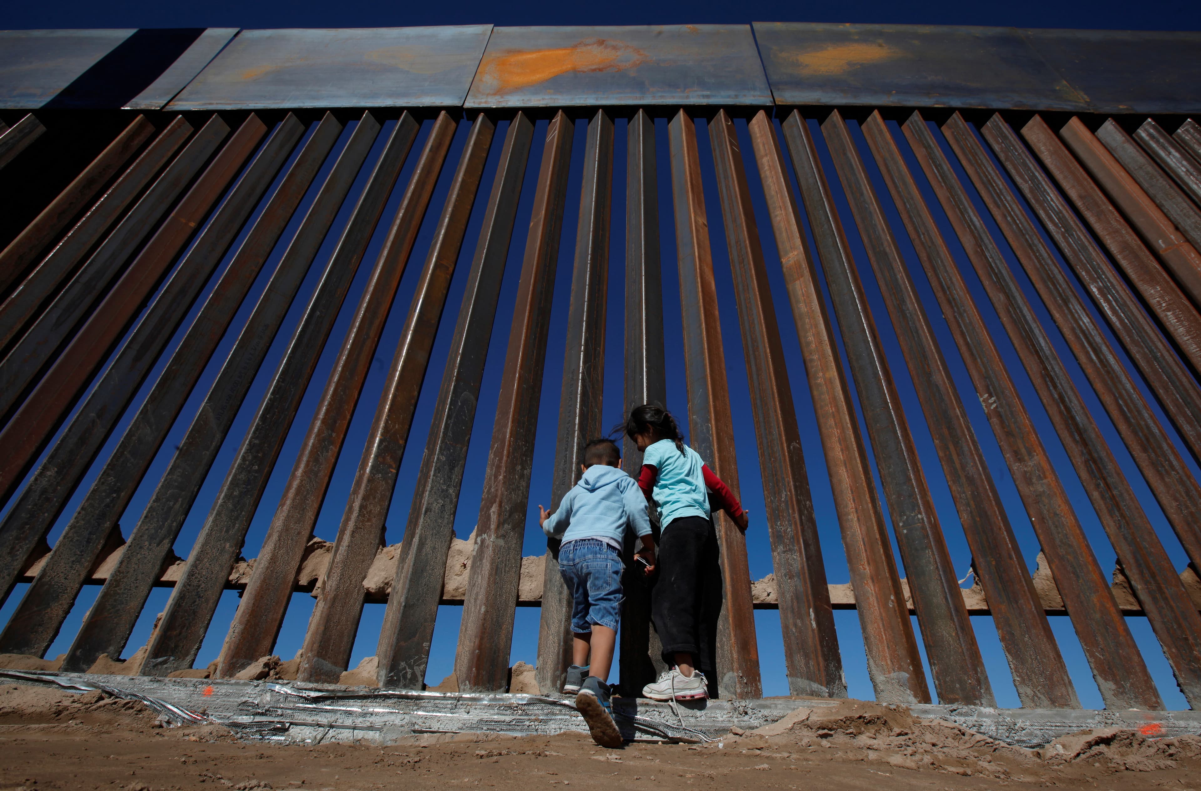 wall with two people at bottom looking up
