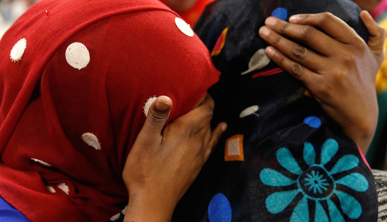 Asma Abdinasir (L), a Somali national who was initially denied entry to the US because of the recent travel ban, is greeted by her mother Zahra Warsma