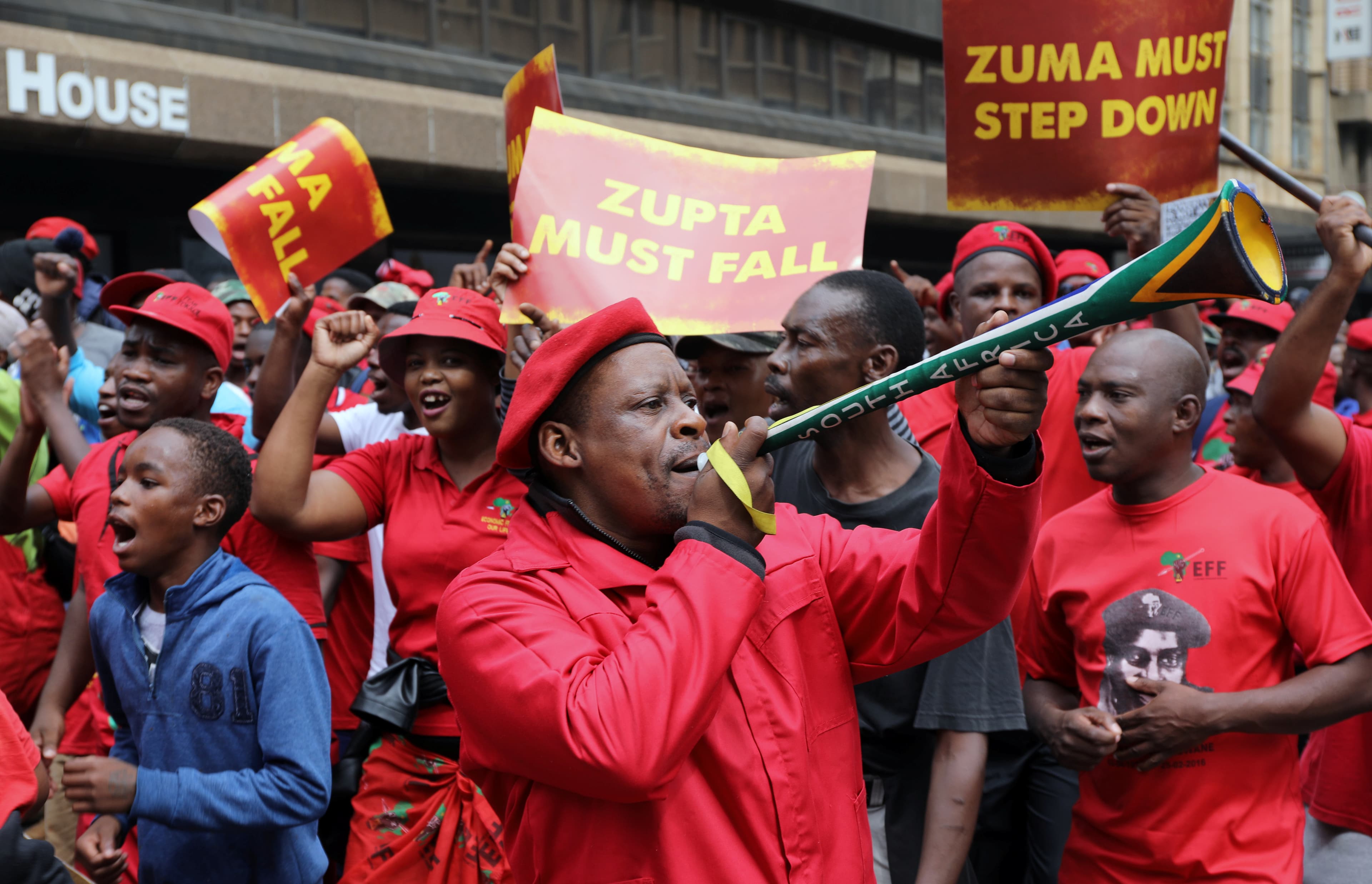 Protesters hold placards as they march in South Africa's capital to protest against President Jacob Zuma in Pretoria, South Africa, April 12 ,2017.