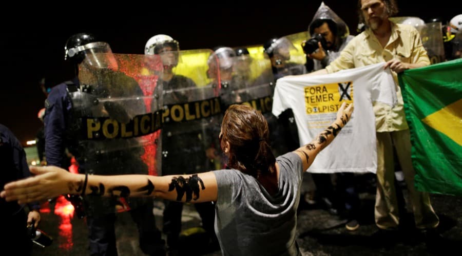 A demonstrator confronts riot police during a protest against Brazil's President Michel Temer in front of the Planalto Palace in Brasilia, Brazil, on May 18.