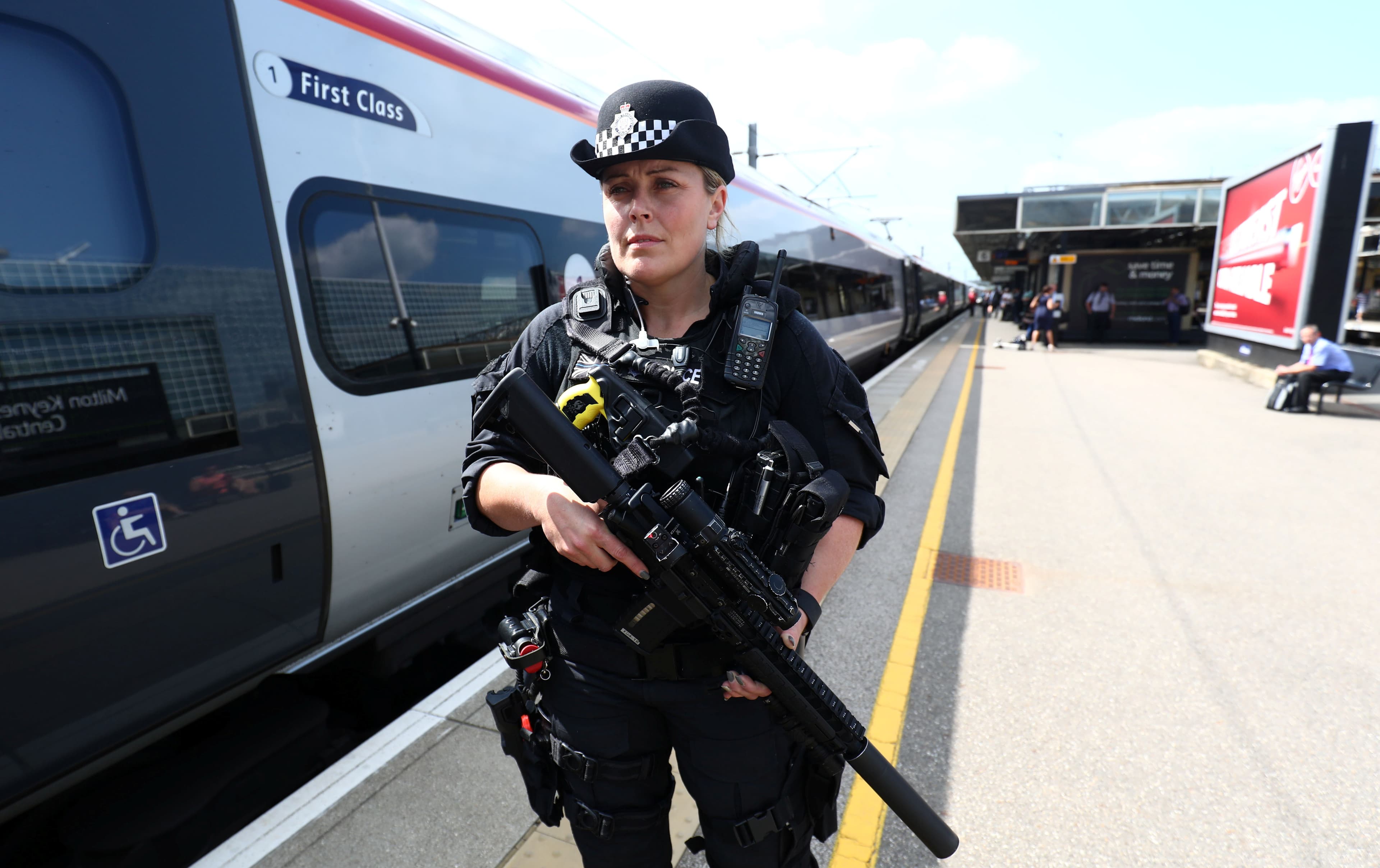 An armed police officer patrols on a platform at Milton Keynes station after the terror threat level was raised to critical following a suicide bombing in Manchester.