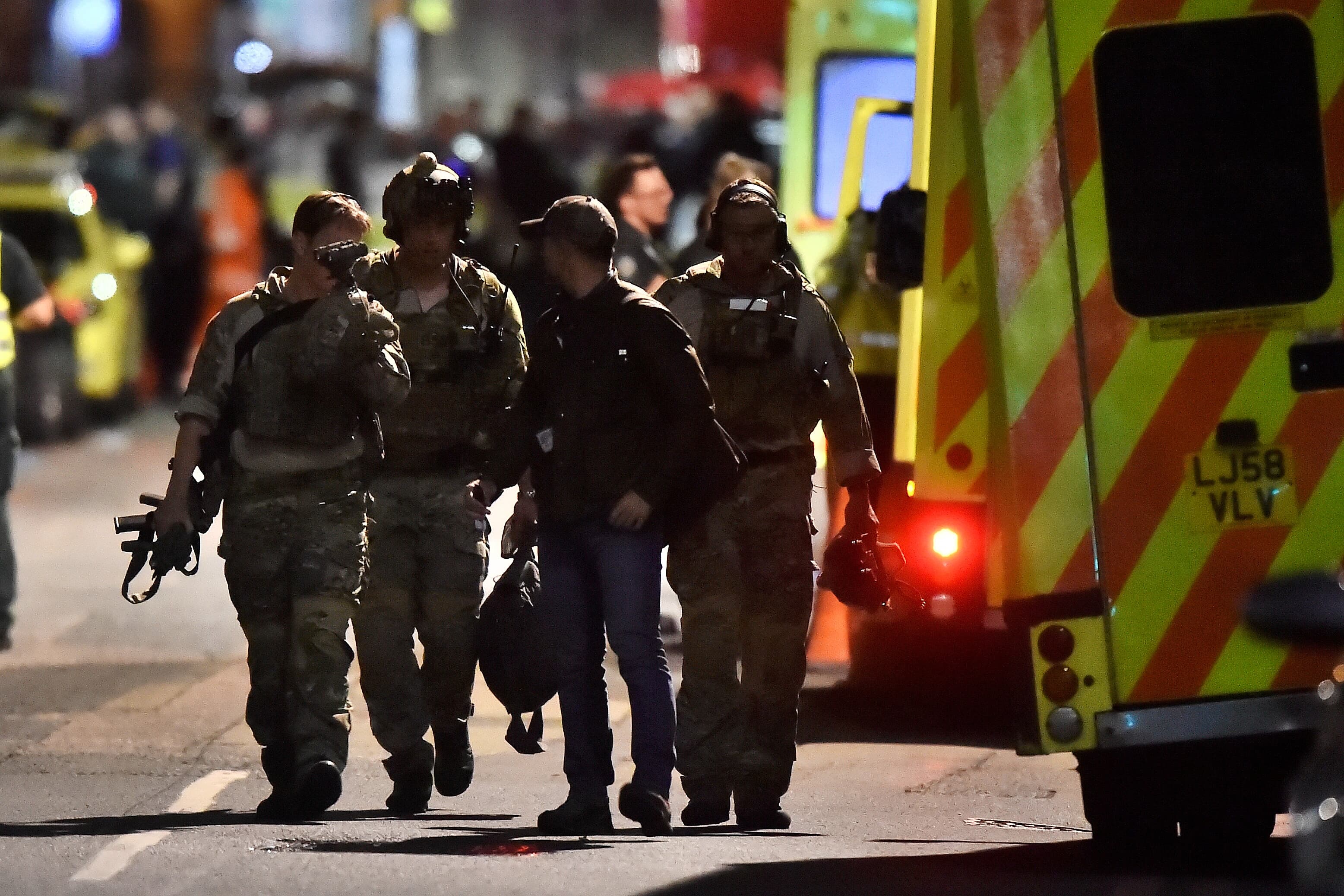 Armed officers attend to an incident near London Bridge in London, Britain, June 4, 2017.