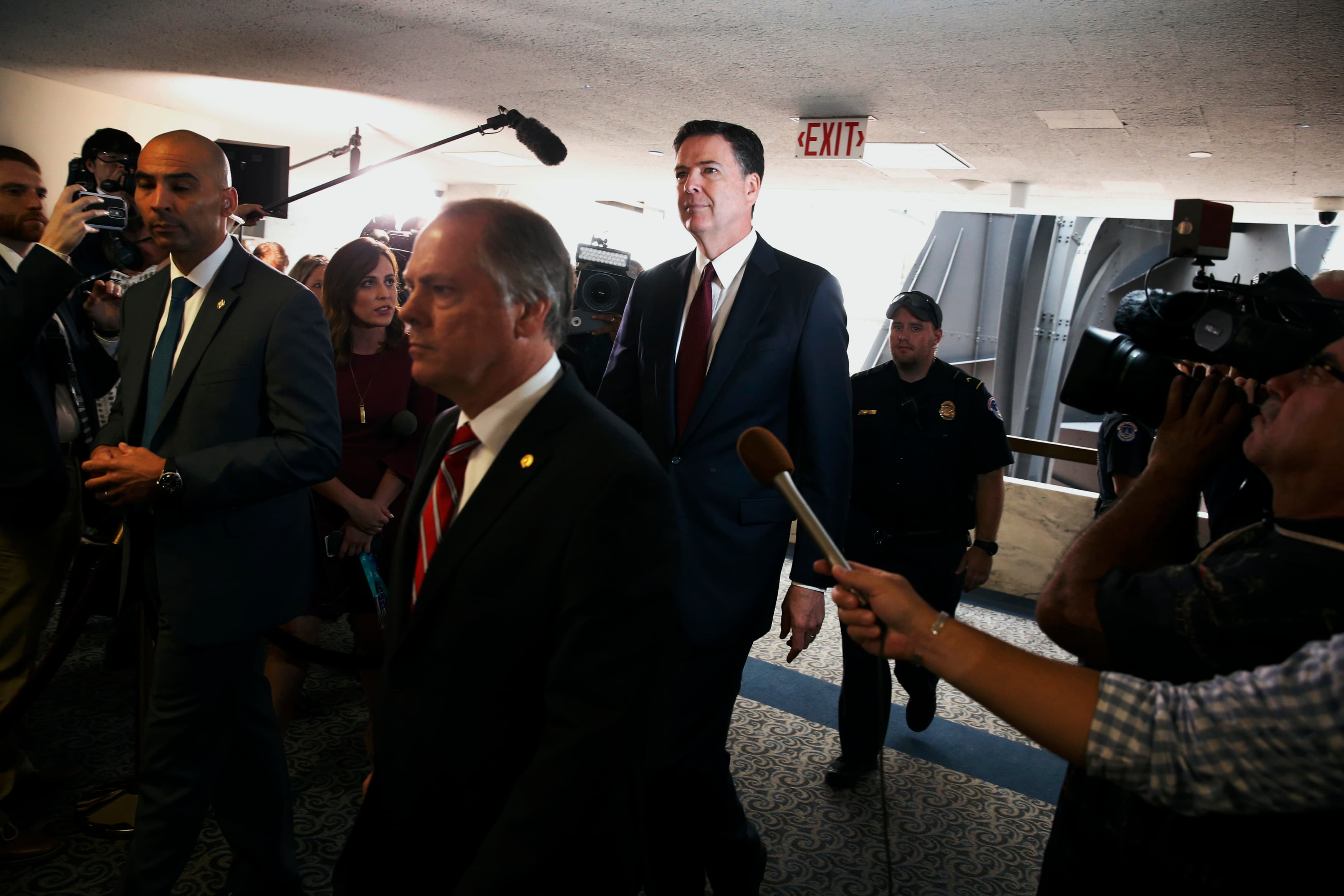 Comey walks through press