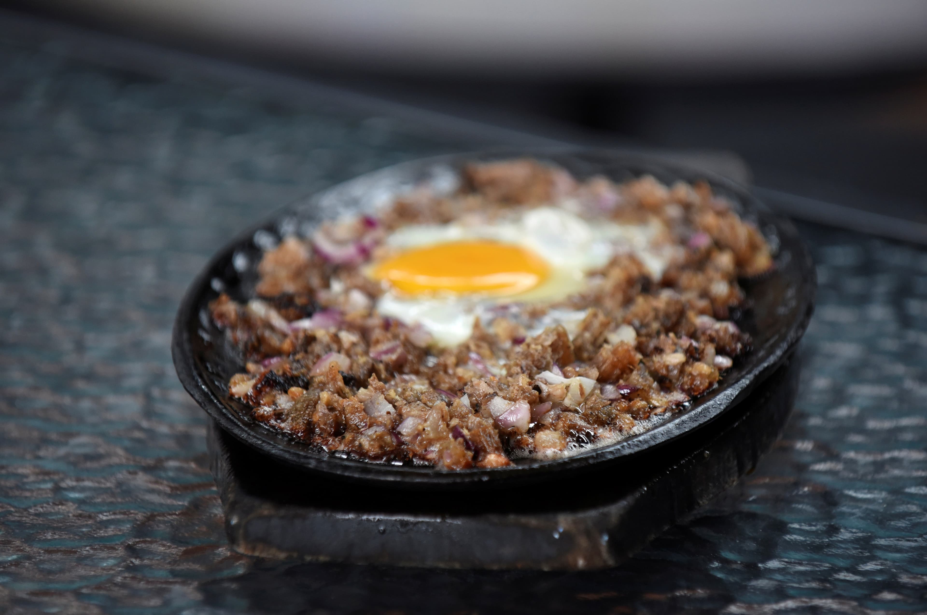 small skillet on stove with ground meat dish cooking