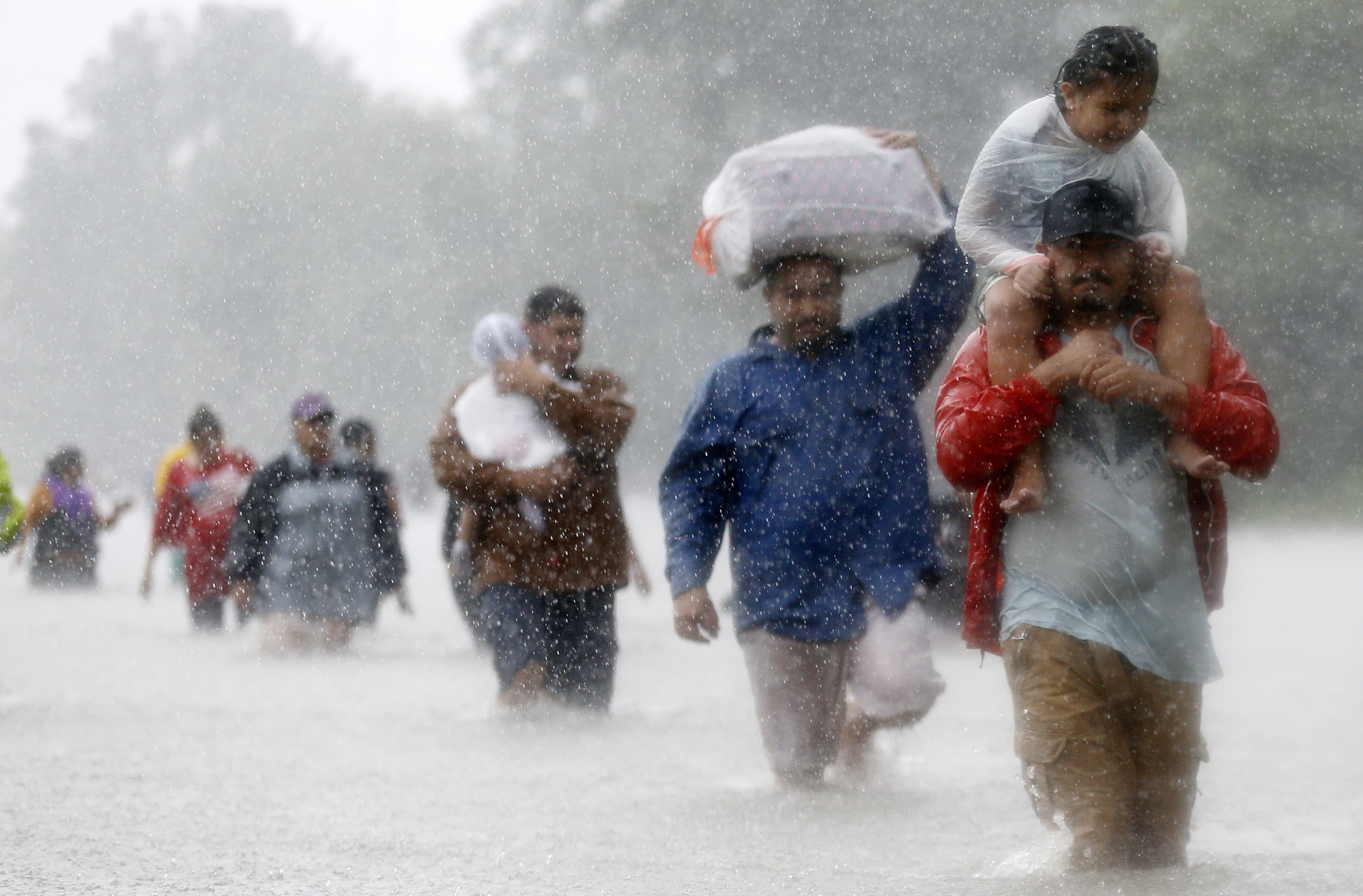 Residents wade through floodwaters from Tropical Storm Harvey in Beaumont Place, Houston.