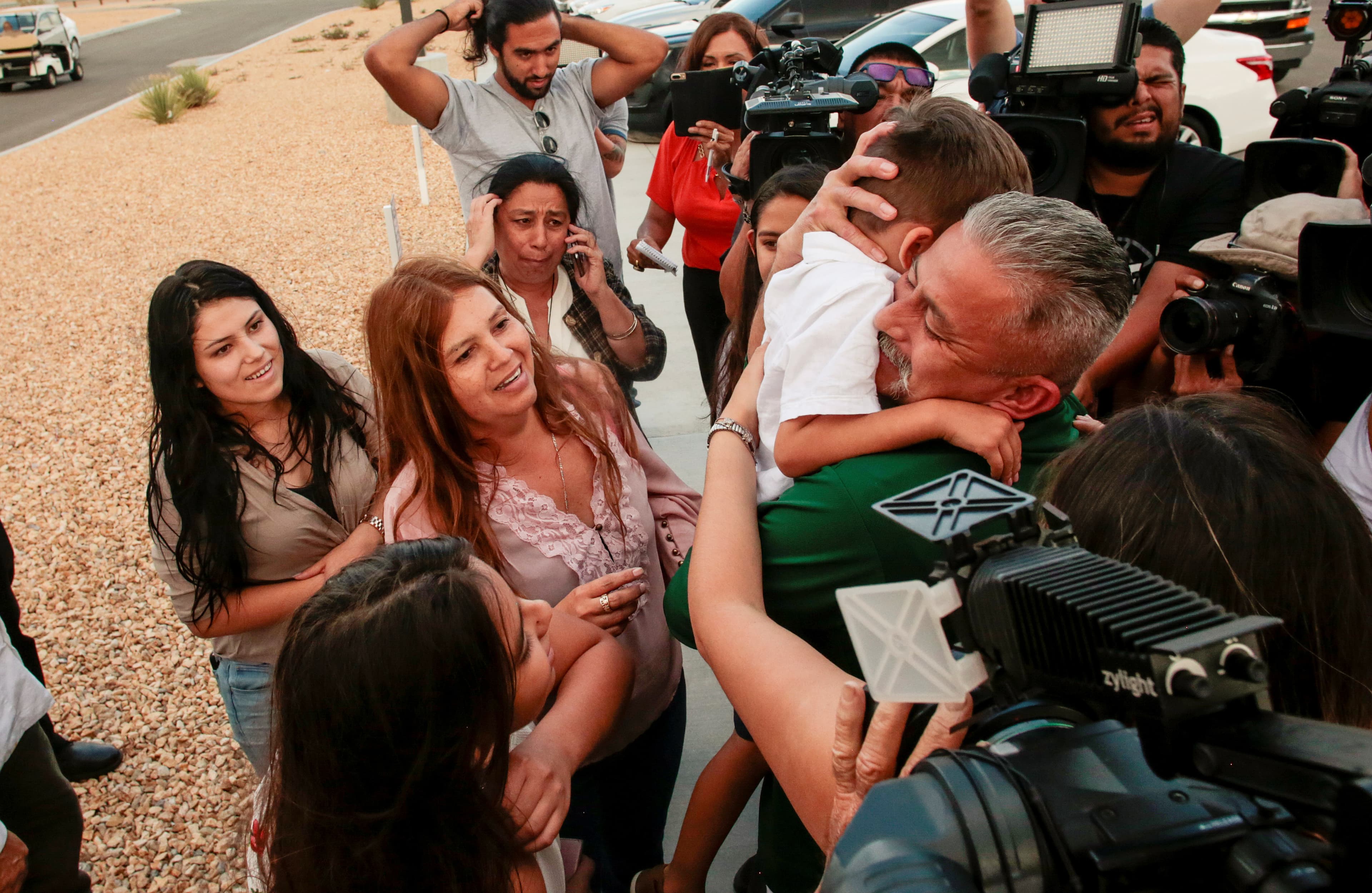 Man in crowd hugging child, photo from above