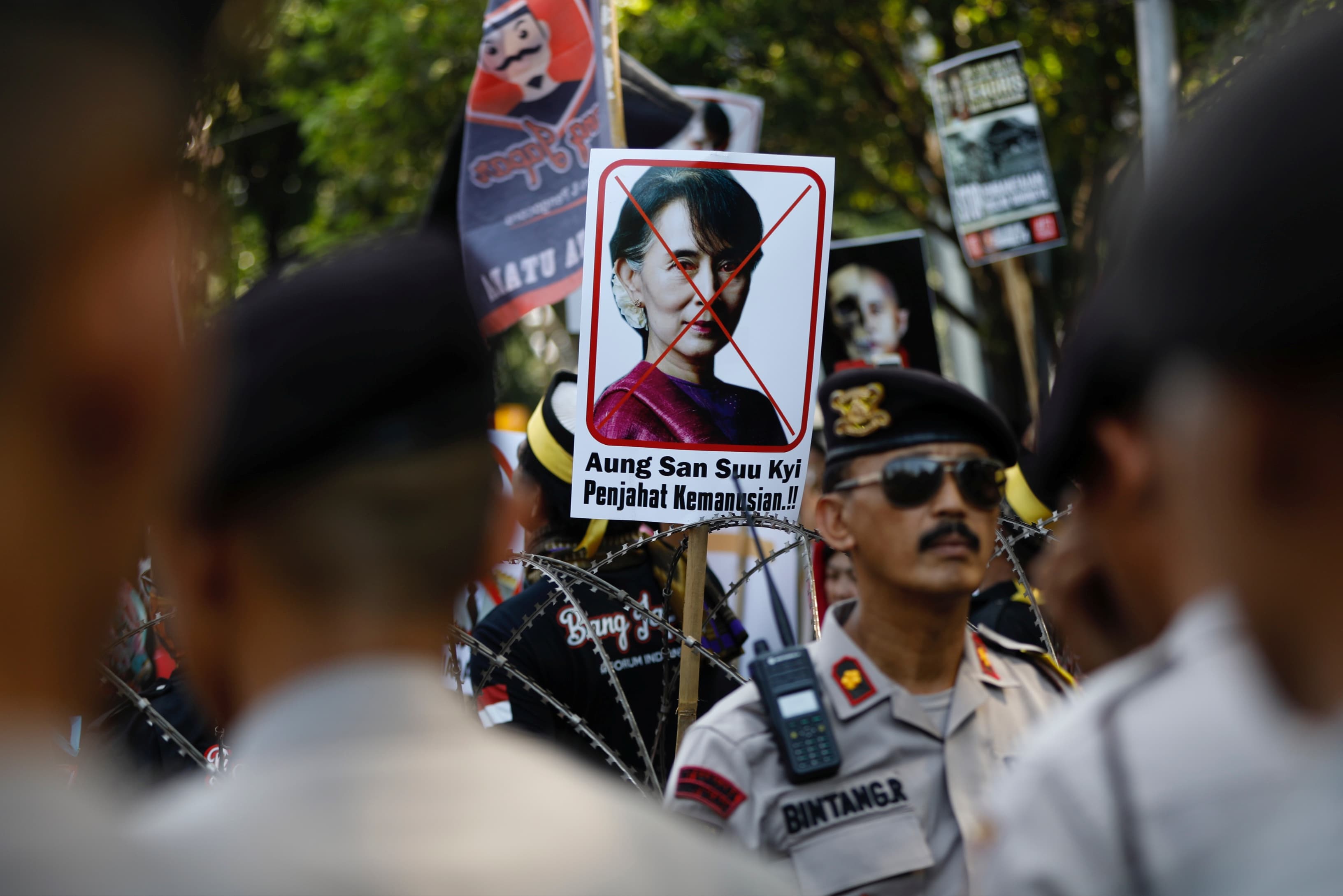 A placard with the picture of Aung San Suu Kyi, accusing her of crimes against humanity, is seen at a rally near the Myanmar embassy in Jakarta.