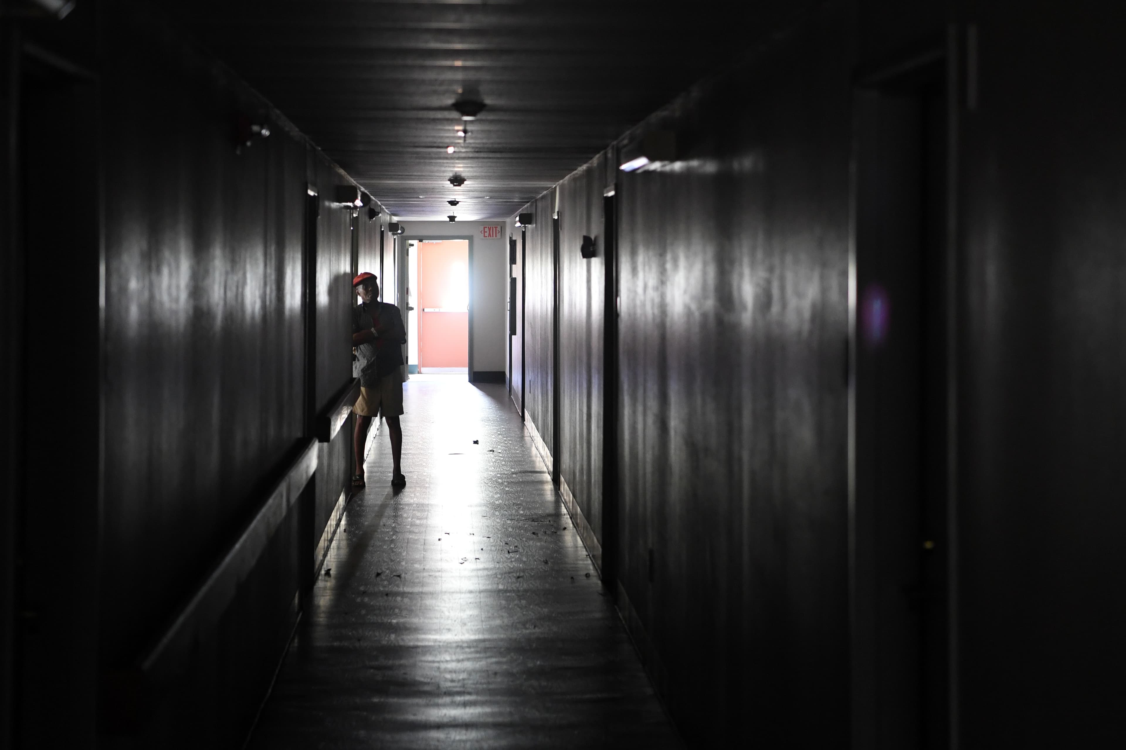 Two days after Hurricane Irma, an elderly resident stand in a dark hallway at Cypress Run, an assisted living facility without power, food, or water, in Immokalee, Florida, U.S., September 12, 2017.