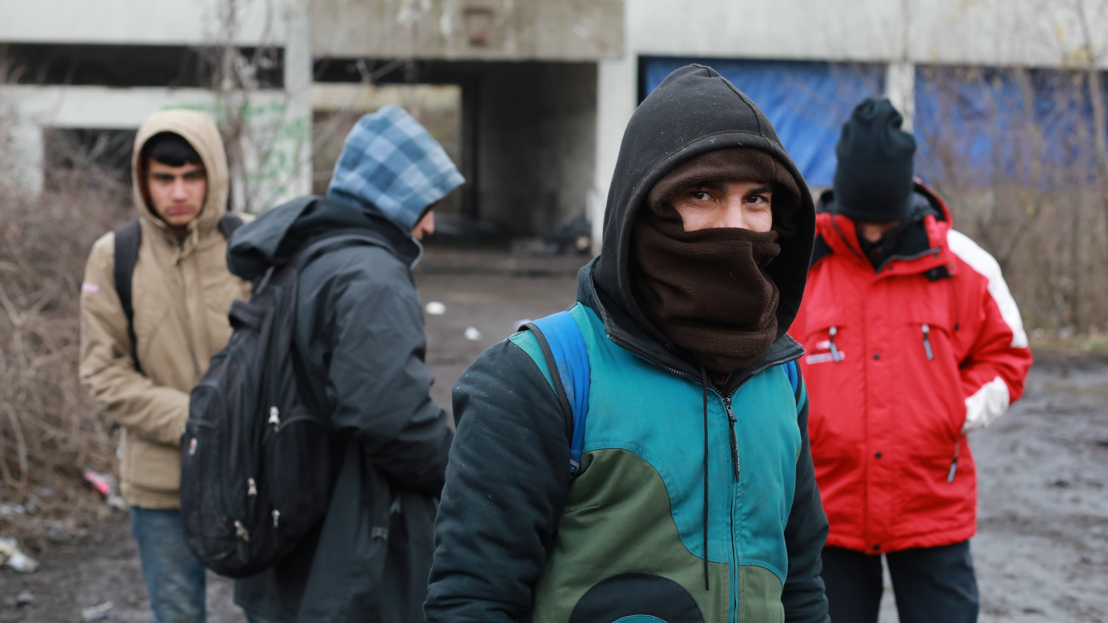 Migrants wait for food distribution inside an abandoned factory close to the Croatian border near the town of Sid, Serbia, Dec. 19, 2017. There are about 8,000 refugees and migrants stranded in Serbia, a result of a tougher European border policies that f