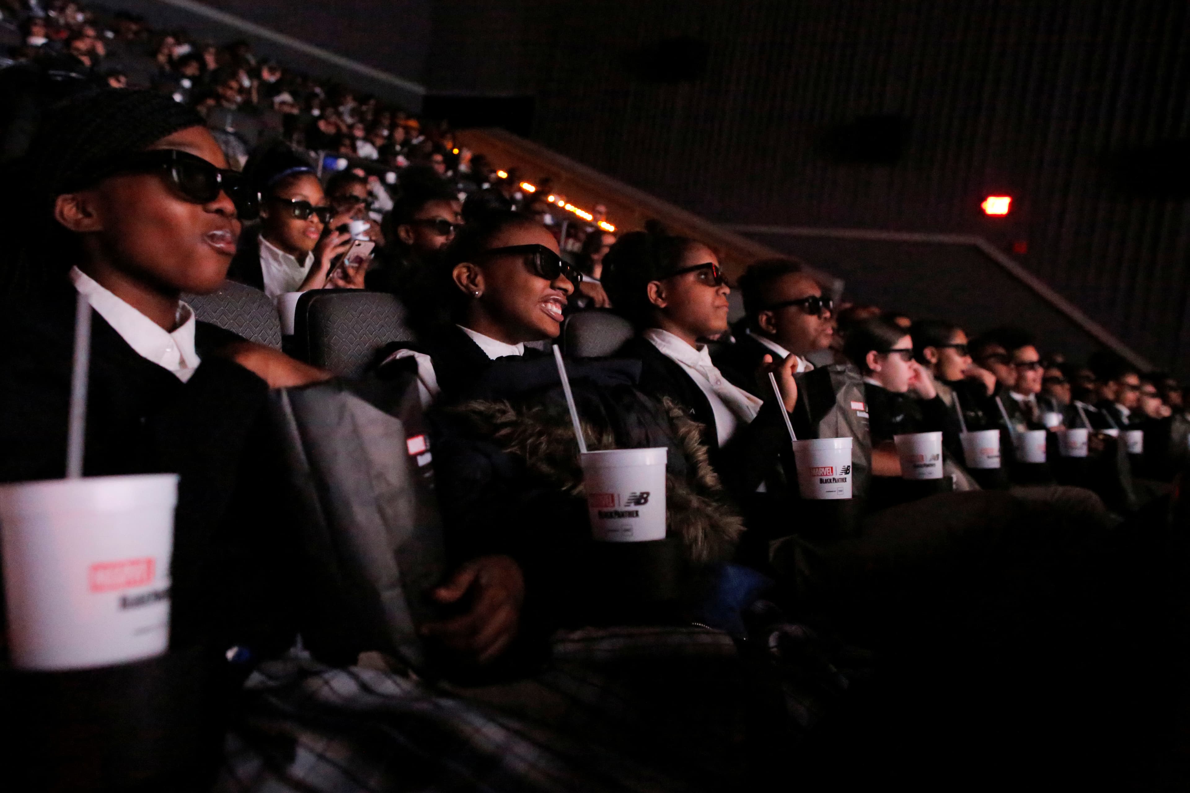 Students from the Capital Preparatory Harlem School watch a screening of the film "Black Panther" on its opening night.