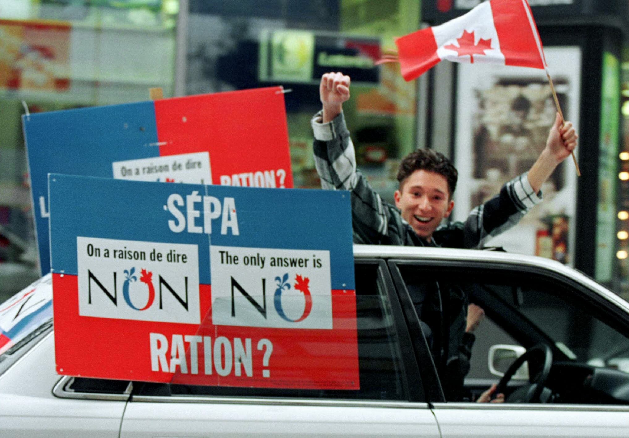 A "No" supporter yells from a moving car while taking his message through the streets of downtown Montreal during Quebec's 1995 referendum on secession from Canada.