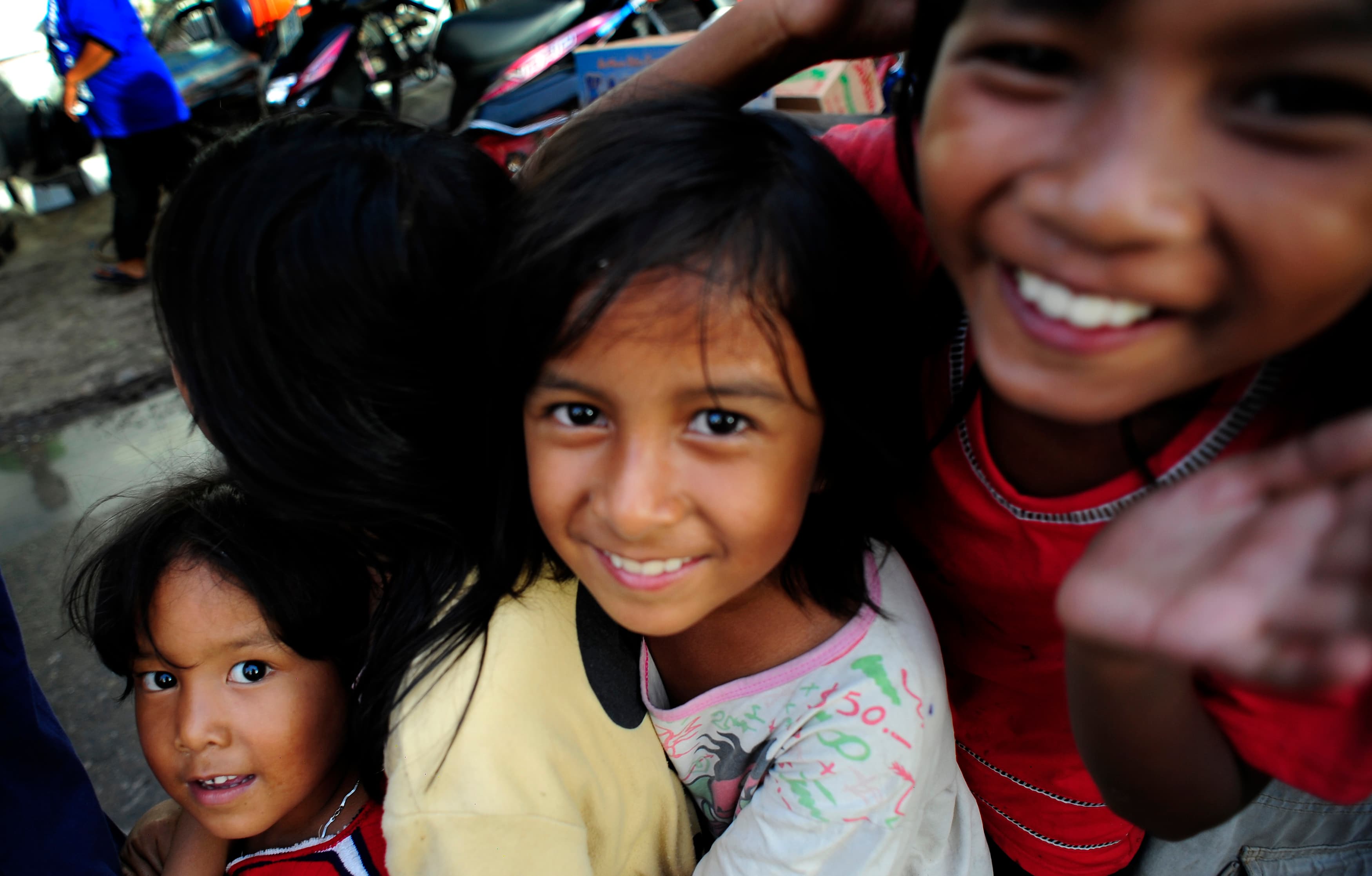 Children queue for aid at a makeshift center erected by a charity in an earthquake-damaged district of Padang, Indonesia's West Sumatra, 2009.