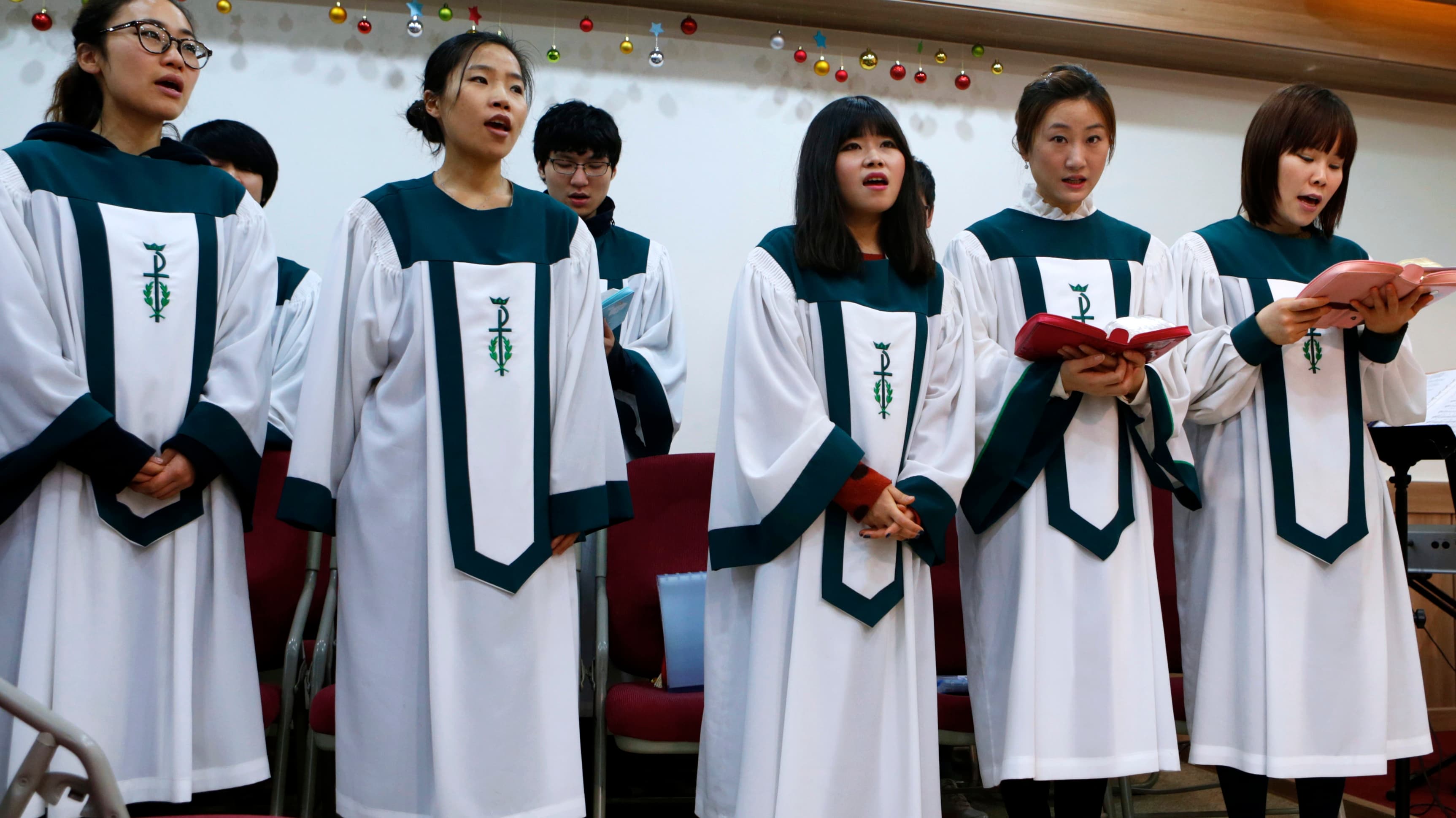 North Korean defectors living in Seoul, South Korea sing a hymn during a prayer service for peace and reunification of the divided Korean Peninsula in April 2013.