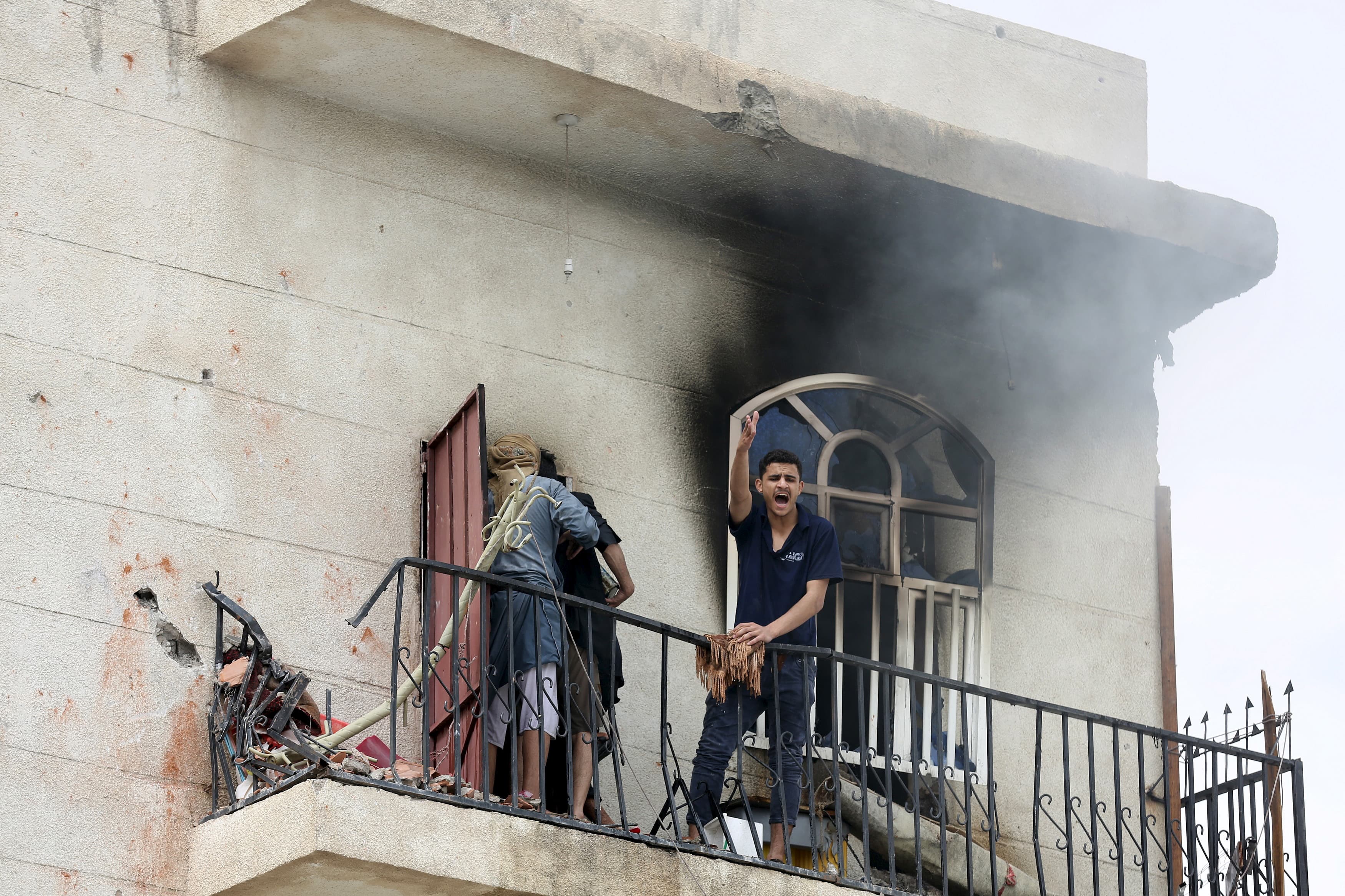 A man reacts at the site of an air strike in Sanaa on April 8, 2015.