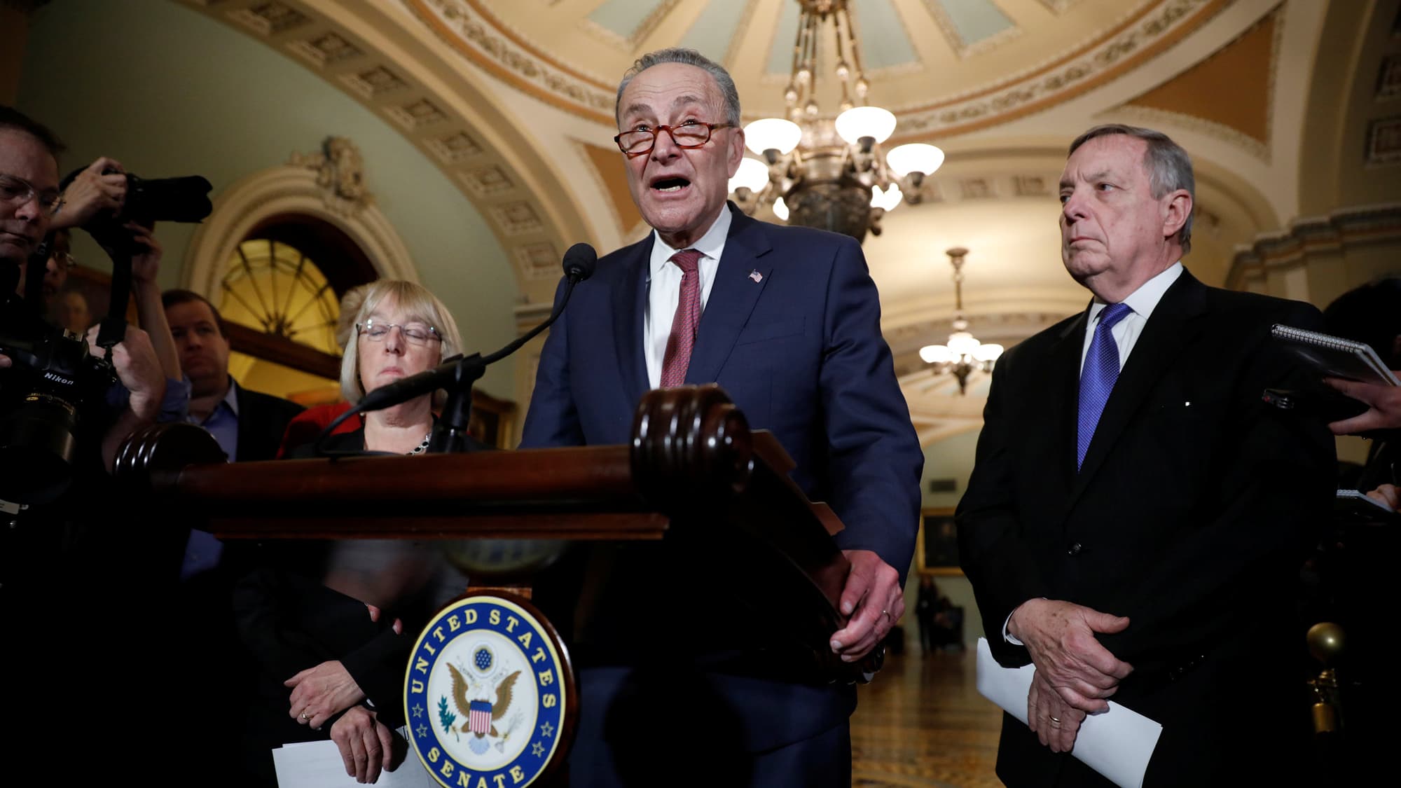 Senate Minority Leader Chuck Schumer, accompanied by Sen. Dick Durbin and Sen. Patty Murray, speaks with reporters in Washington, Jan. 23, 2018.